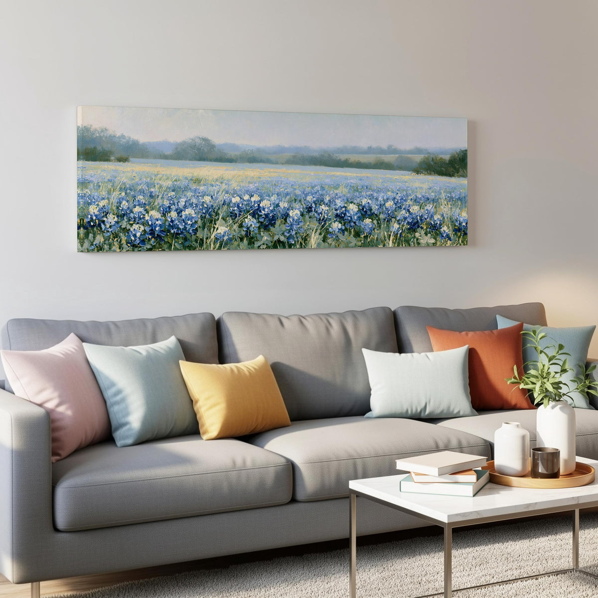 Field of bluebonnets panoramic canvas print above a grey sofa in a living room