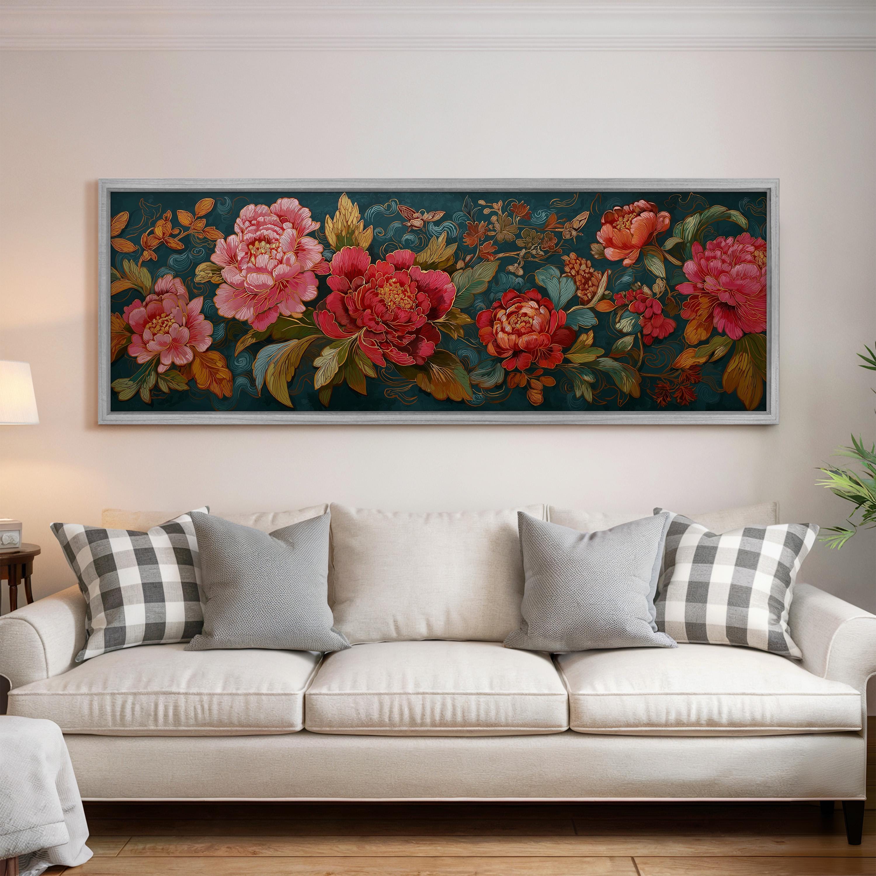 a large, colorful floral painting hanging on a wall above a white couch with gray and white plaid throw pillows.