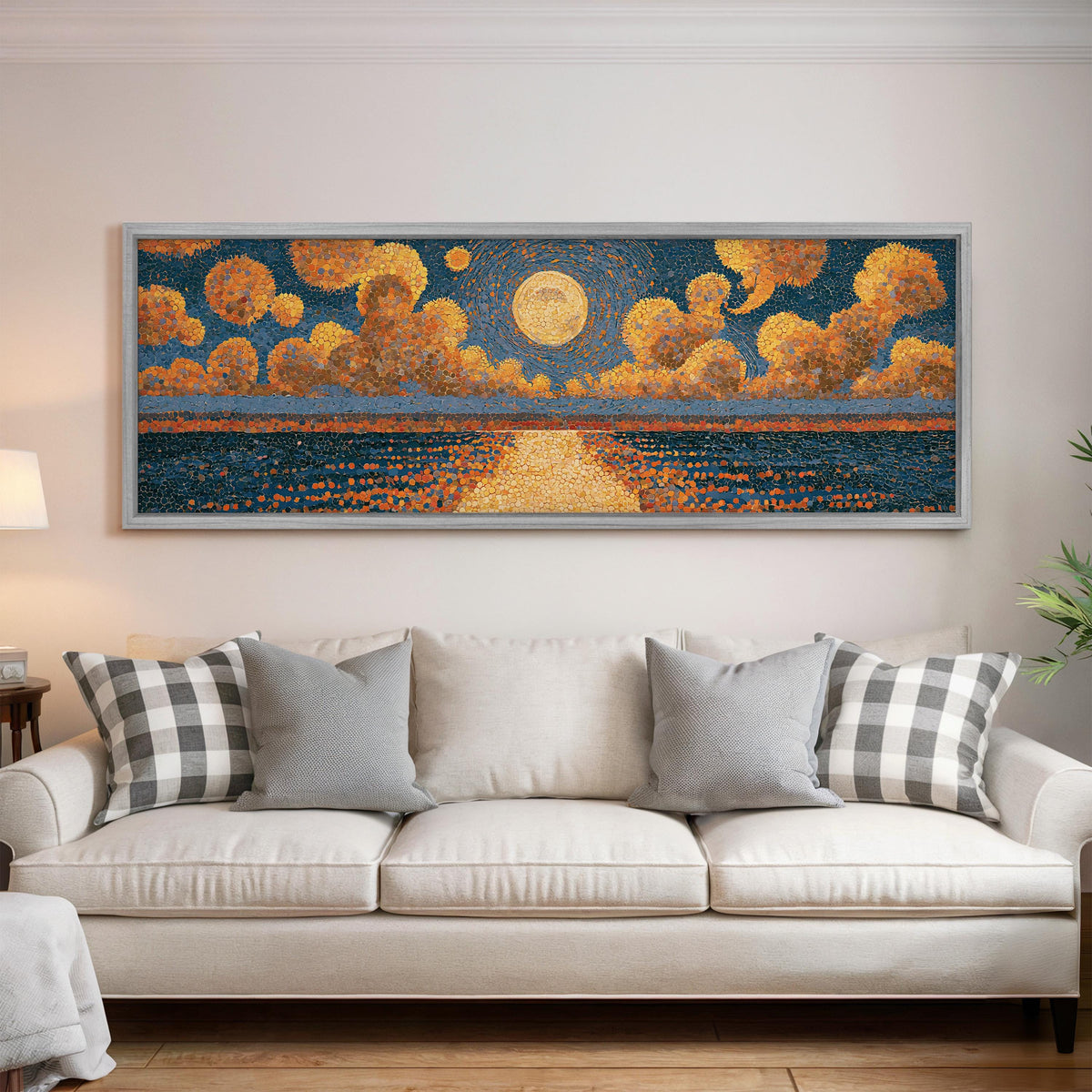 Golden sunset over a lake panoramic canvas print above a white sofa in a bright living room