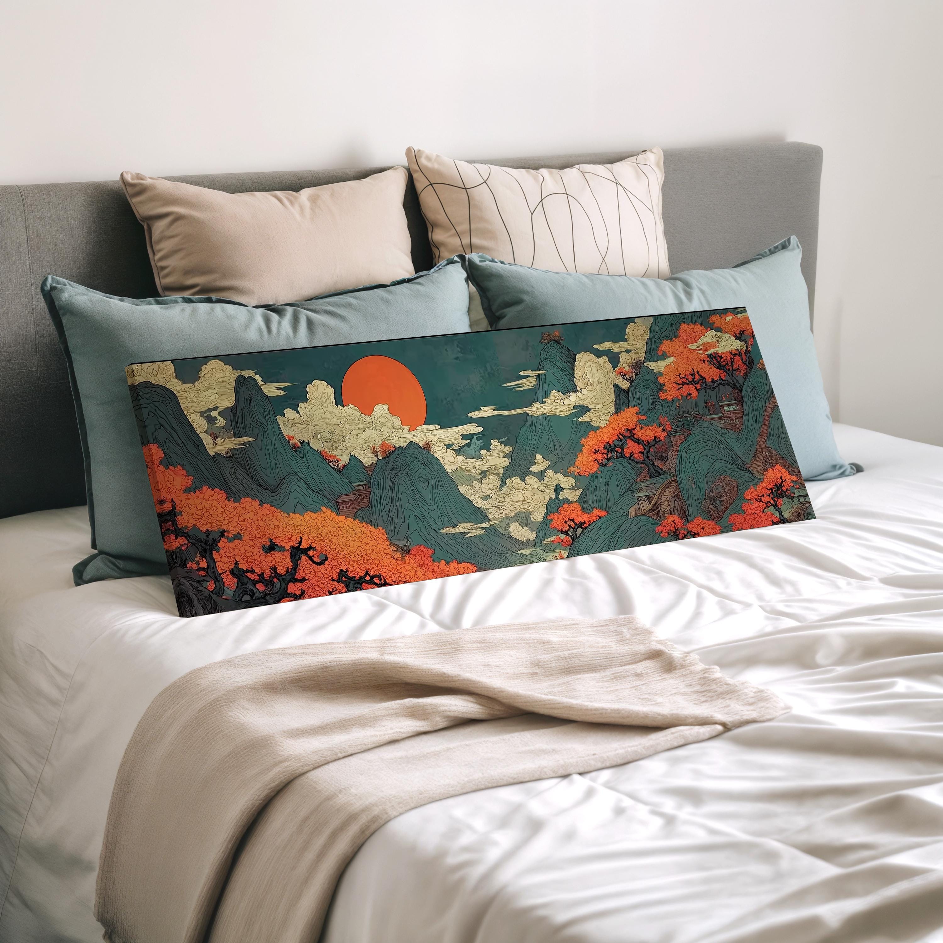 a large, colorful painting of a landscape with mountains, trees, and a sun in the sky, displayed on a bed with a white comforter and pillows.