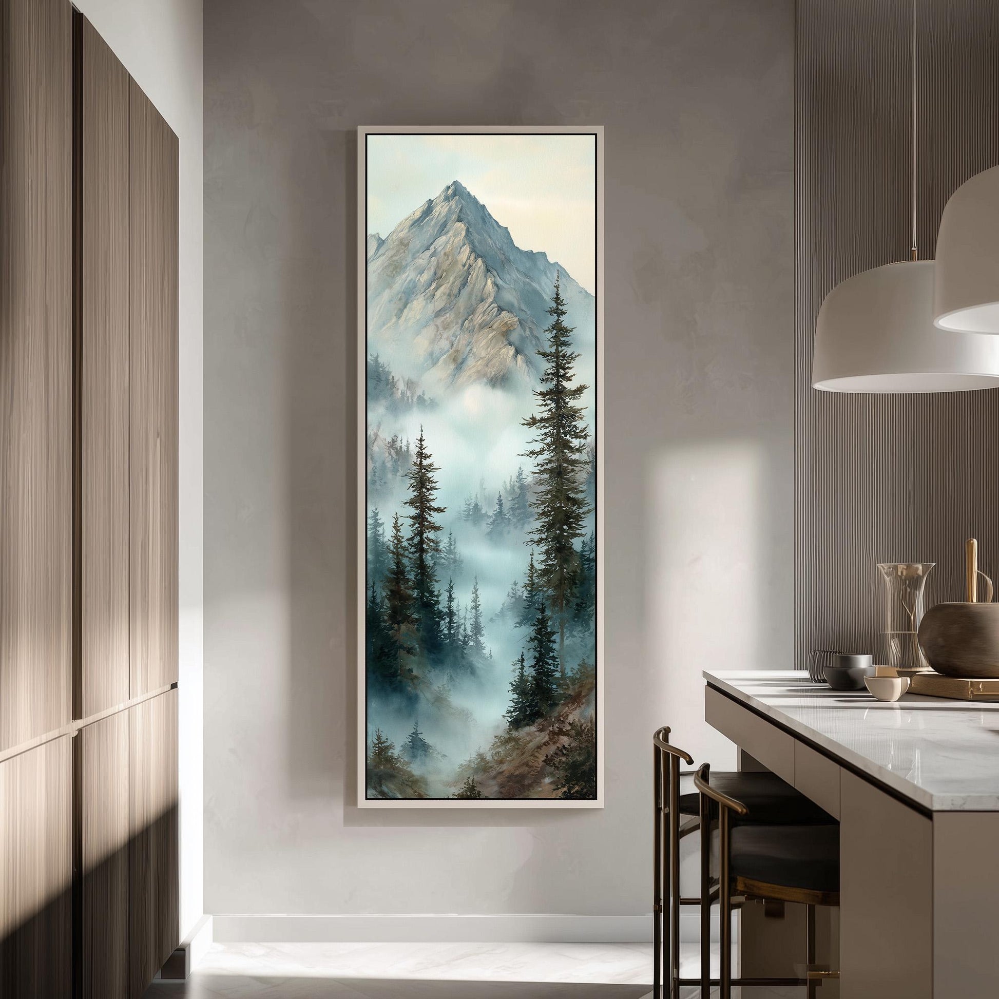 a large framed painting of a mountain landscape with a misty, forested scene. The painting is hanging on a wall in a modern kitchen with a countertop and chairs.