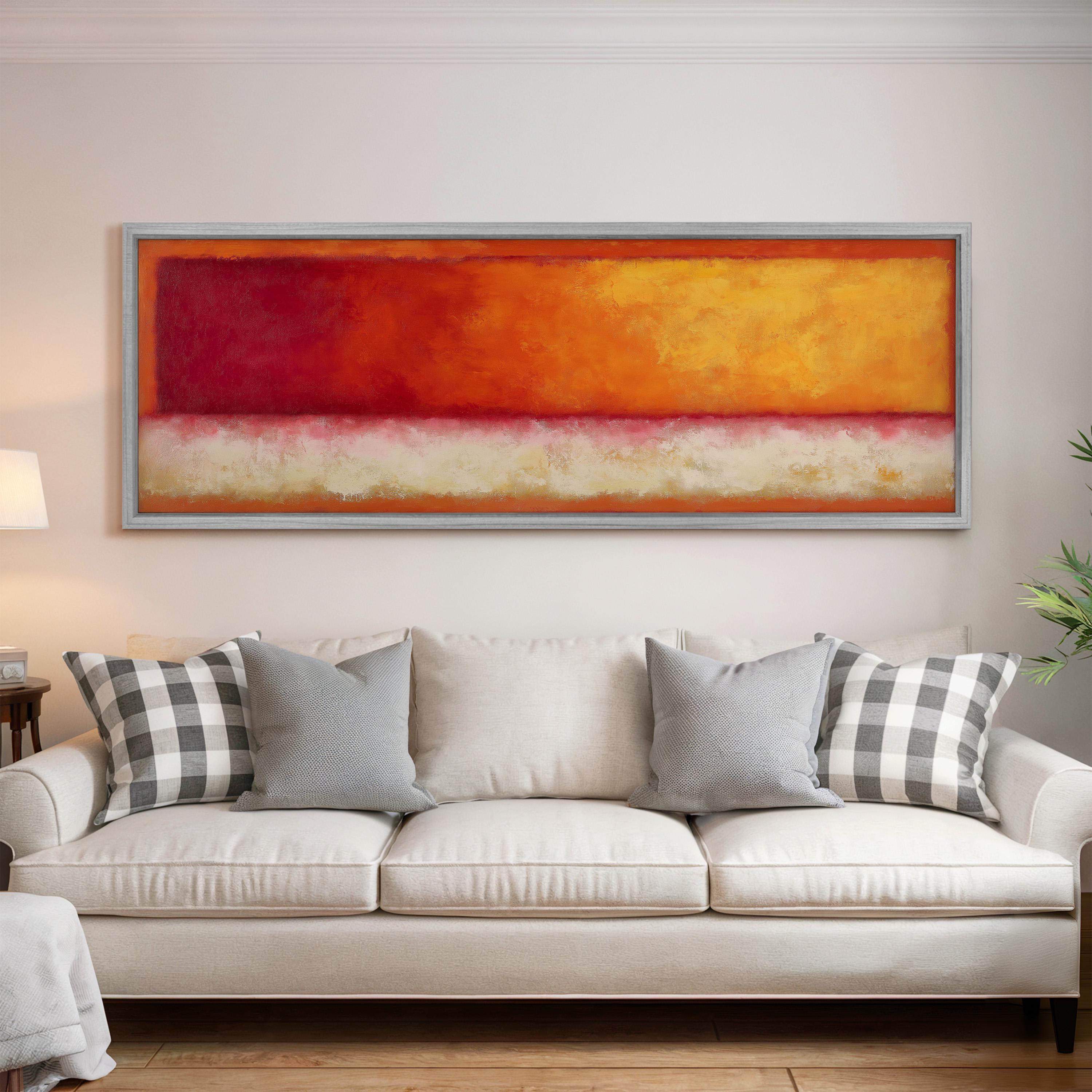 a large, colorful abstract painting hanging on a white wall above a white couch with gray and white patterned pillows.