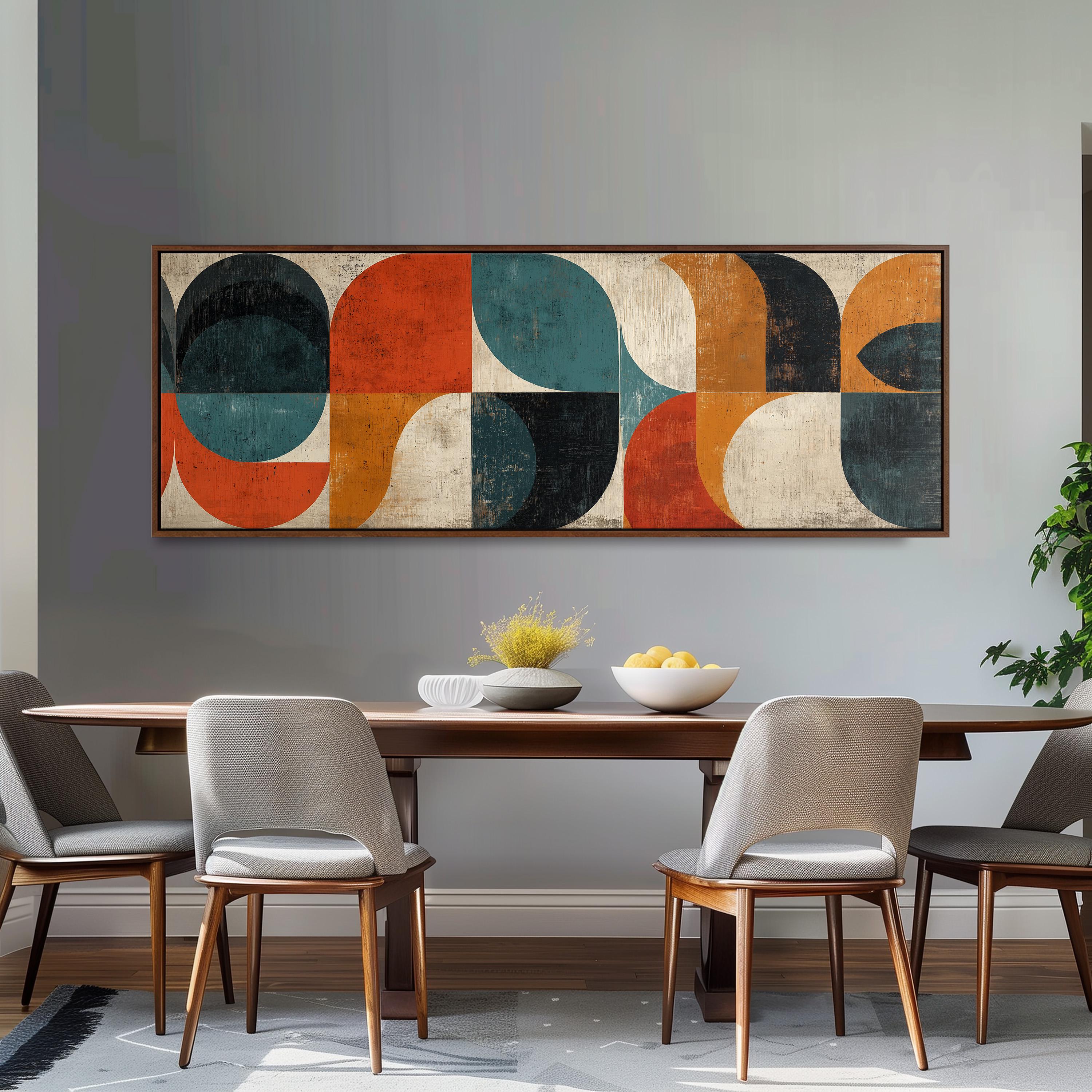 a modern dining room with a large abstract painting hanging on the wall above a wooden dining table with four chairs. The table is set with a bowl of fruit and a vase of flowers, creating a welcoming and stylish atmosphere.