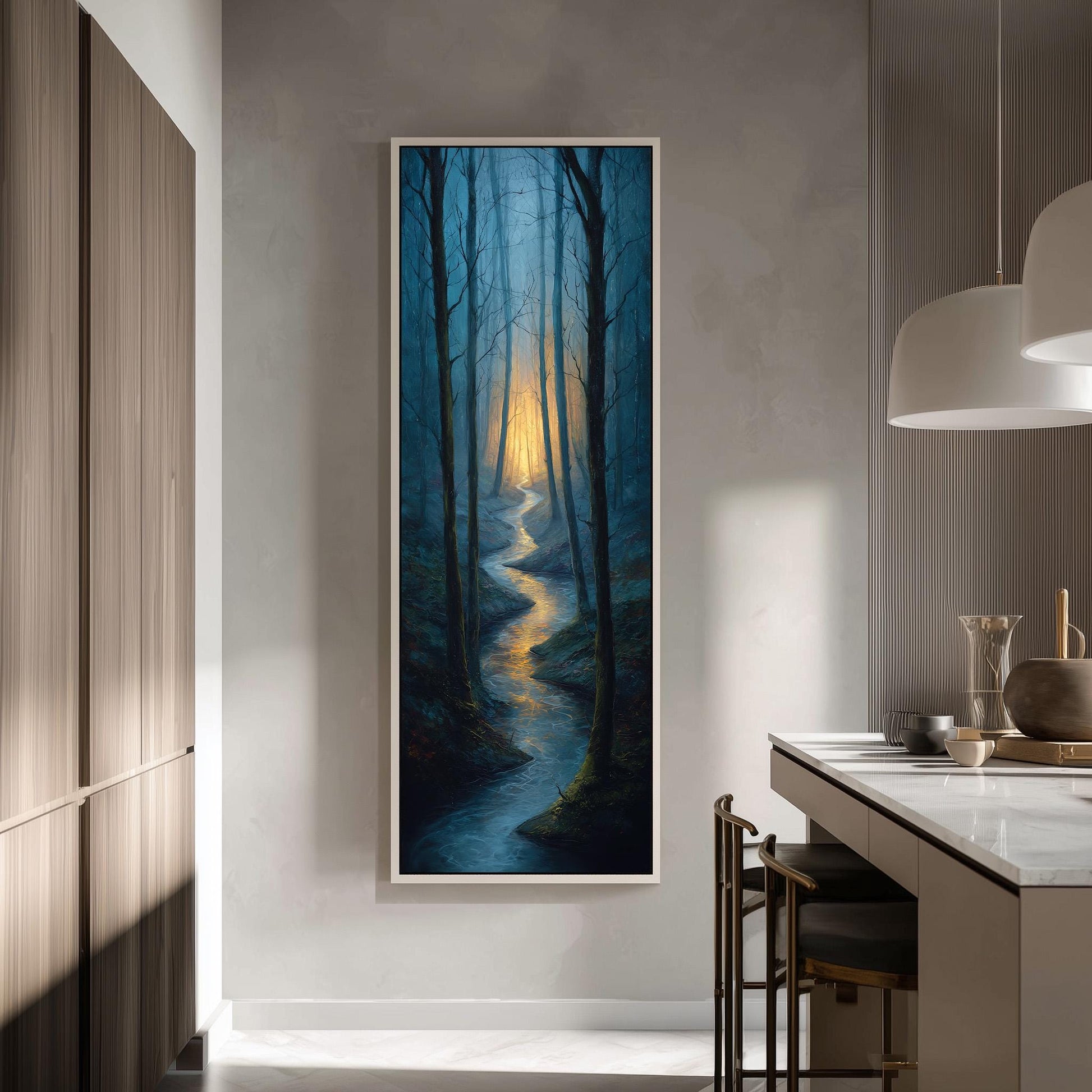 a large, framed painting of a forest scene with a winding path leading through the trees, illuminated by a warm glow. The painting is hung on a wall in a modern, minimalist kitchen setting.