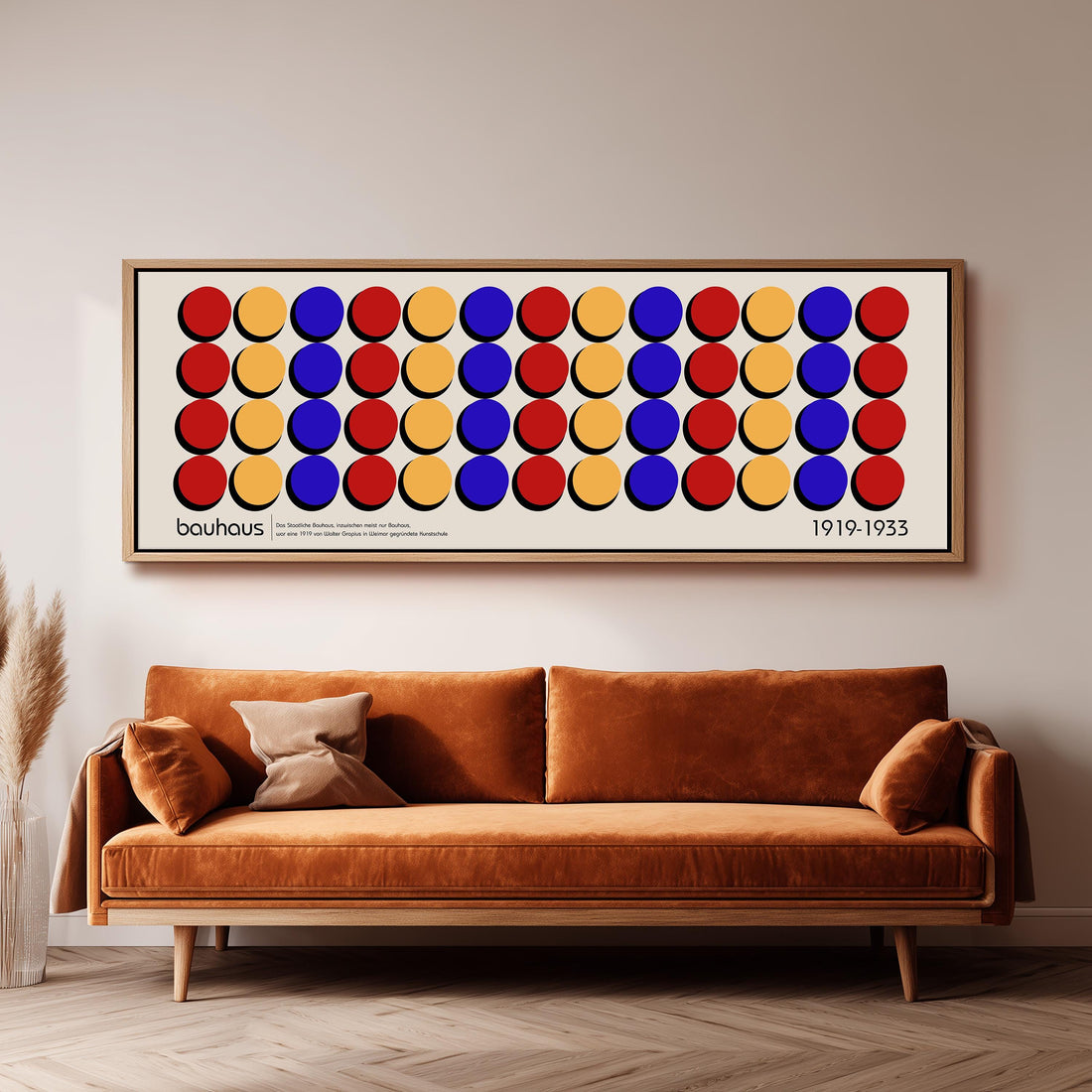 a large framed poster of a repeating pattern of circles in various colors, including red, yellow, blue, and orange, hanging on a wall above a brown sofa.