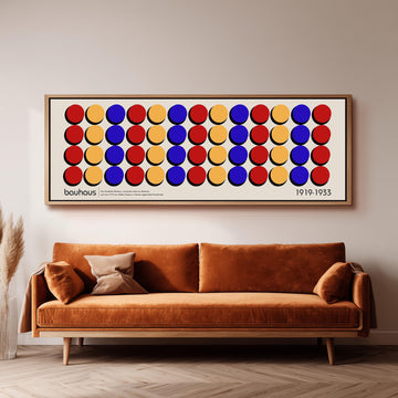 a large framed poster of a repeating pattern of circles in various colors, including red, yellow, blue, and orange, hanging on a wall above a brown sofa.