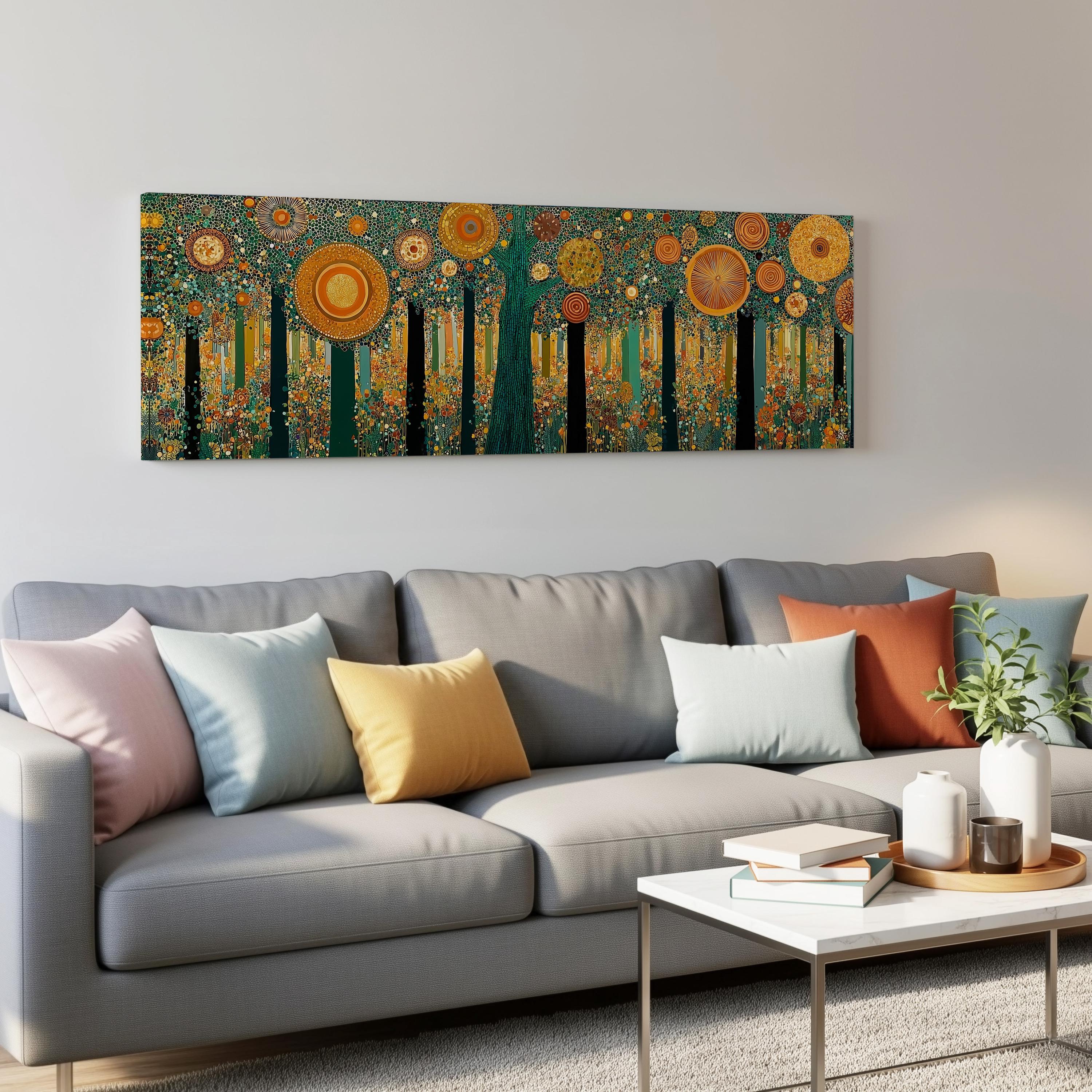 a modern living room with a gray sofa adorned with colorful throw pillows. Above the sofa, a large abstract painting of a forest with vibrant orange and yellow flowers is displayed on the wall. The room also includes a coffee table with books and a plant, creating a cozy and inviting atmosphere.