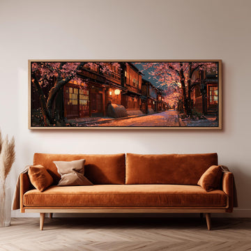 a large, framed painting of a serene street scene with cherry blossoms and traditional Japanese architecture, hanging on a wall above a brown sofa.