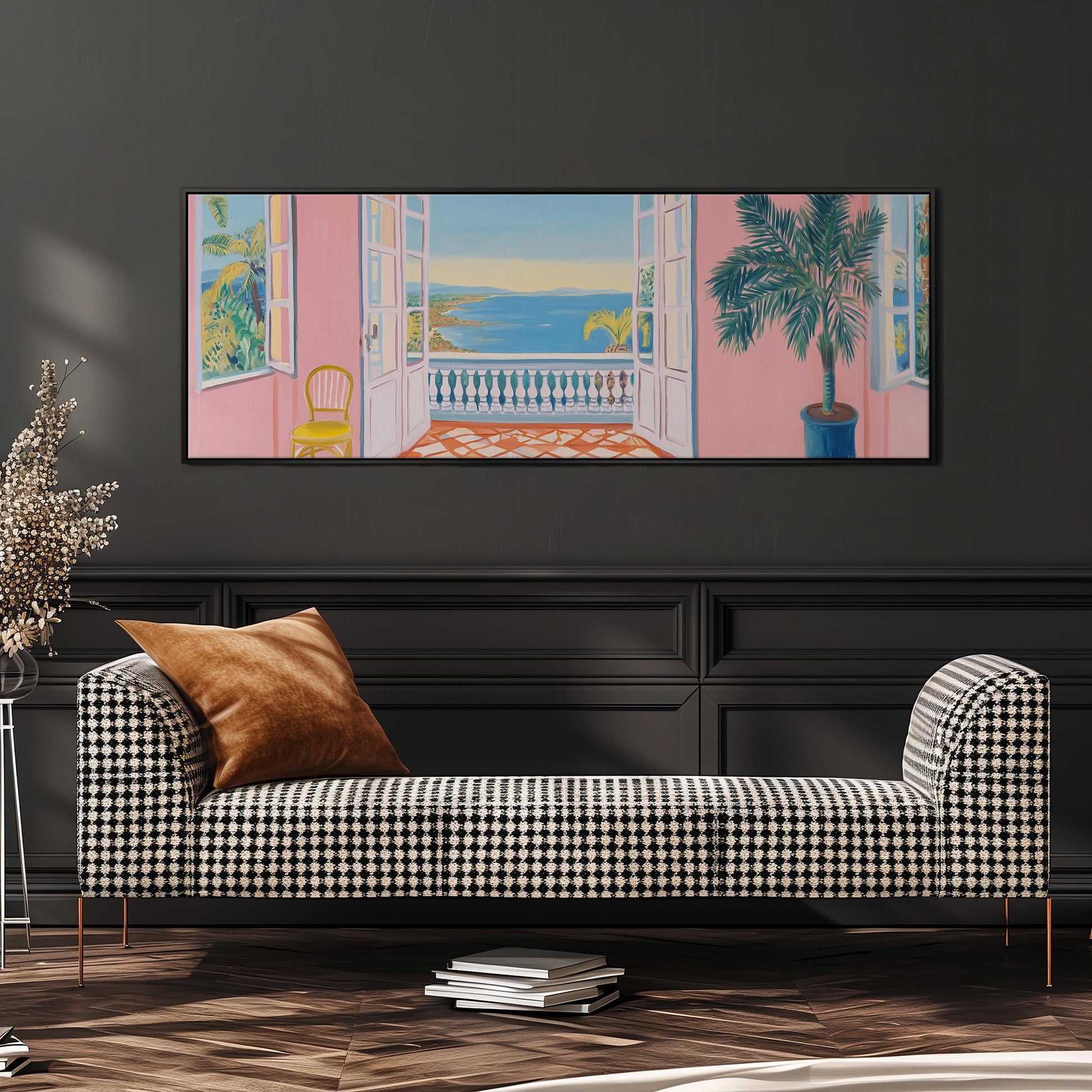 a large, colorful painting of a balcony overlooking the ocean, hanging on a wall above a black and white checkered sofa.