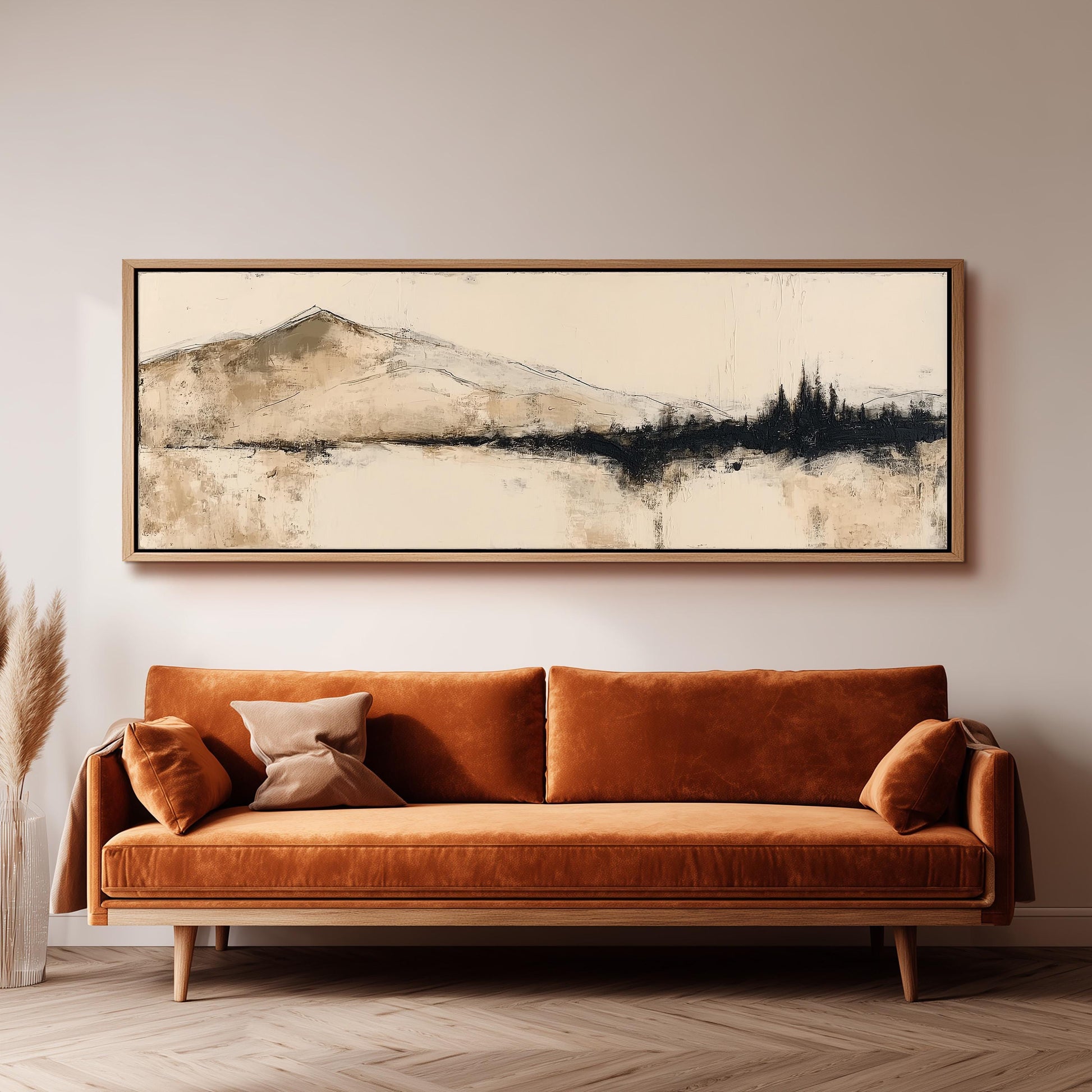 a large, rectangular painting hanging on a wall above a brown sofa with orange cushions.