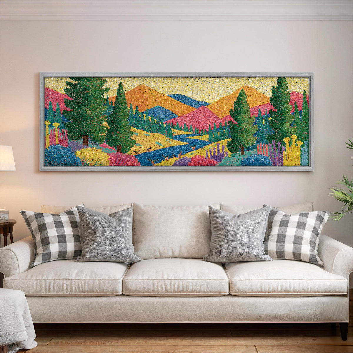 Colorful pine mountain valley panoramic canvas print above a white sofa in a bright living room