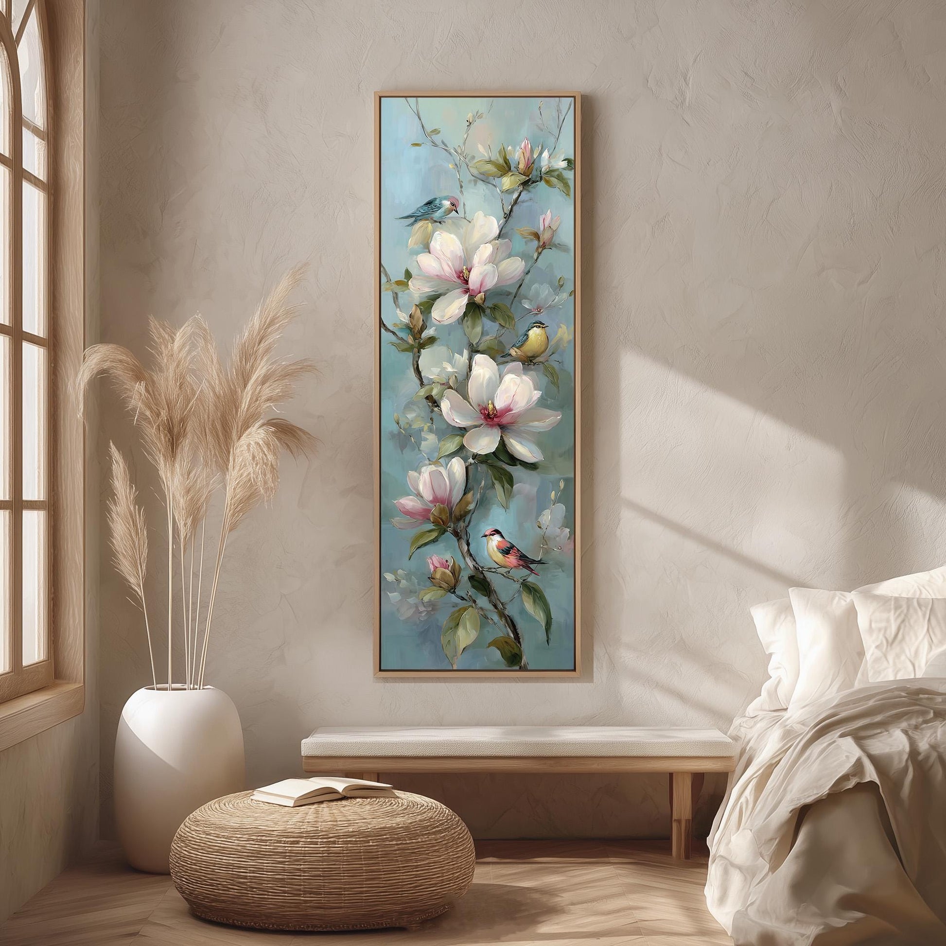 a large floral painting hanging on a wall, with a bed, a potted plant, and a woven ottoman in the foreground.