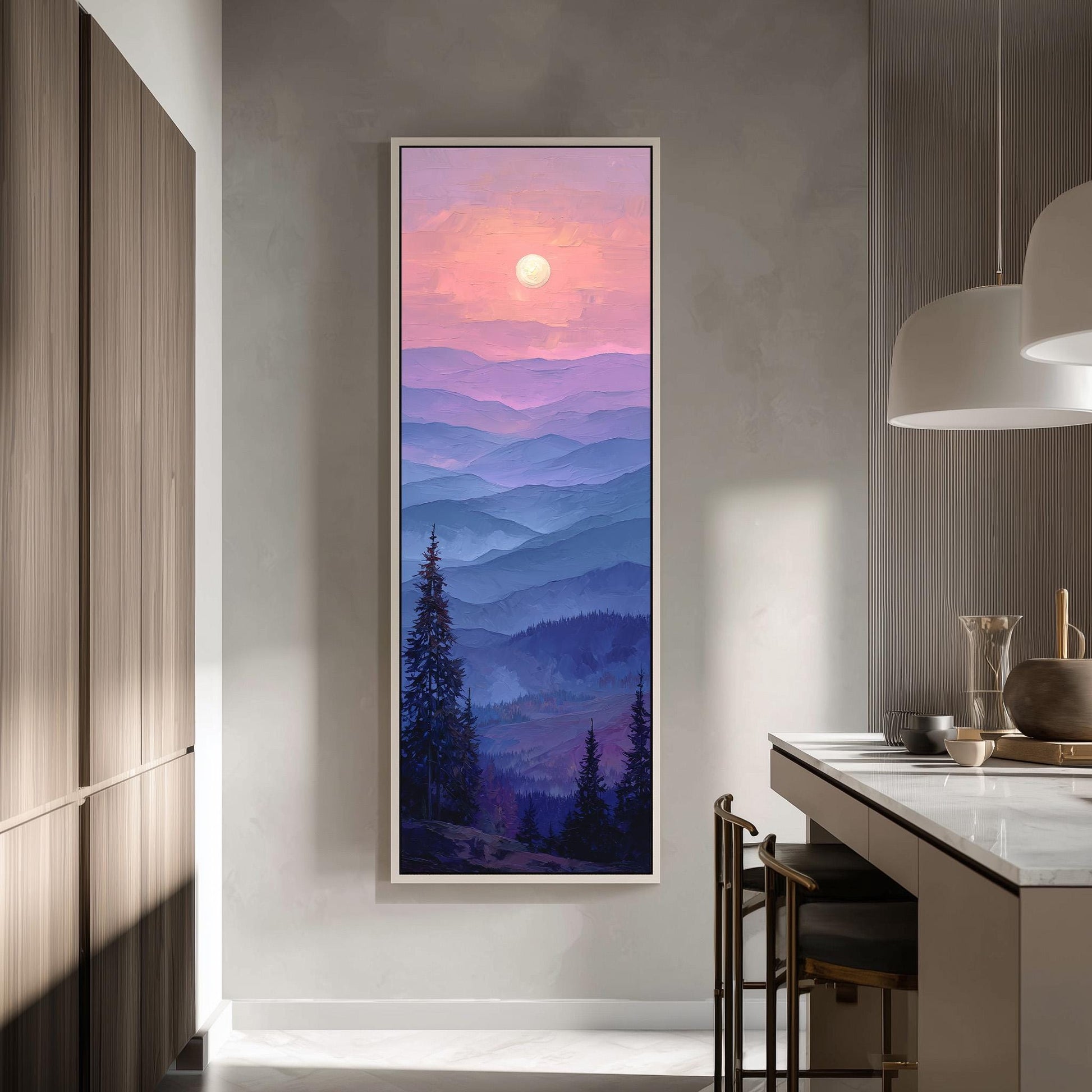 a large framed painting of a mountain landscape with a sunset in the background, hanging on a wall in a modern kitchen.