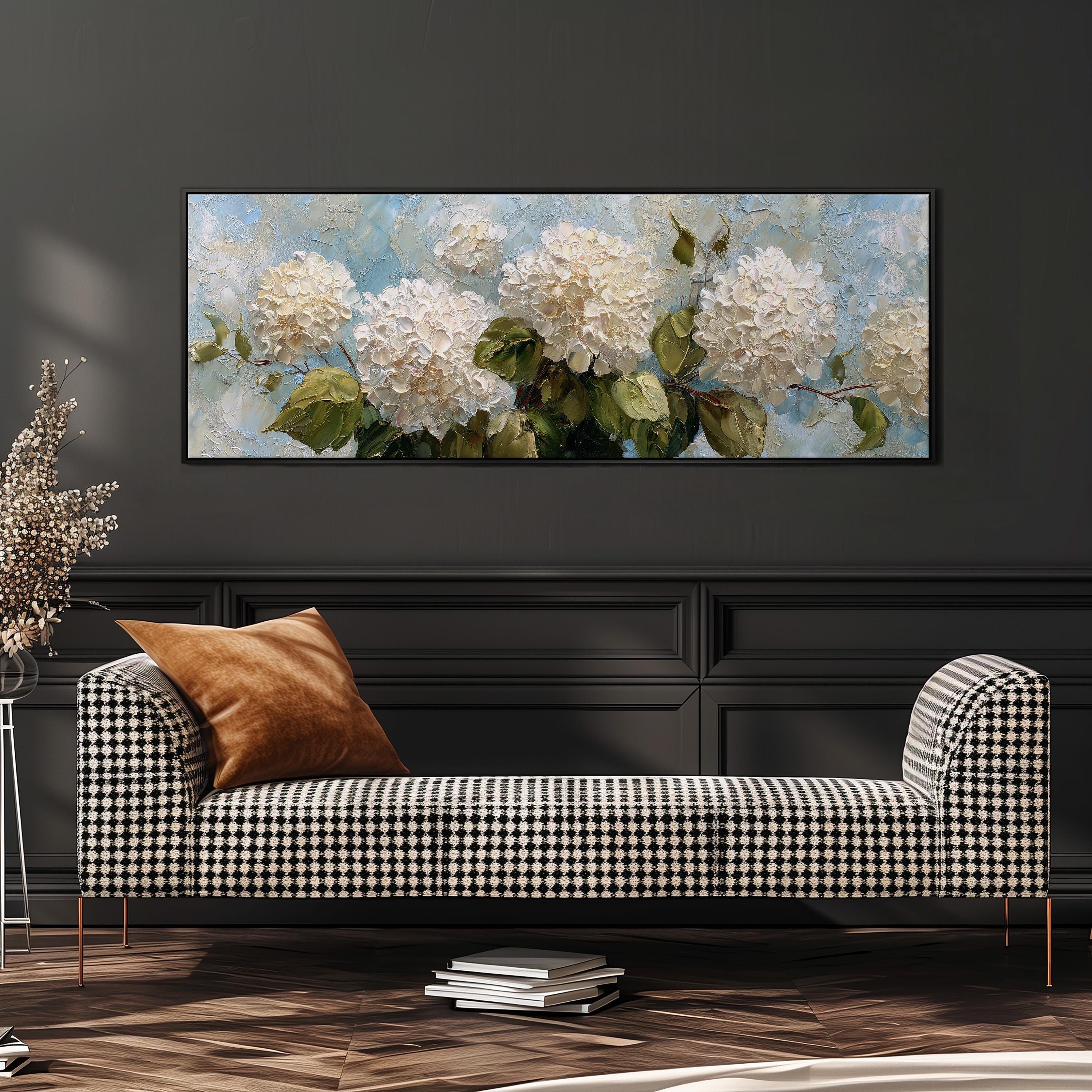 a large painting of white hydrangeas hanging on a wall above a black and white checkered sofa in a living room setting.