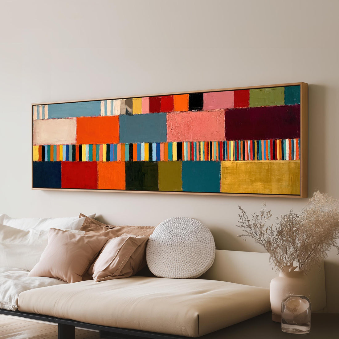 Rainbow patchwork color bands long horizontal canvas print above a sofa in a living room