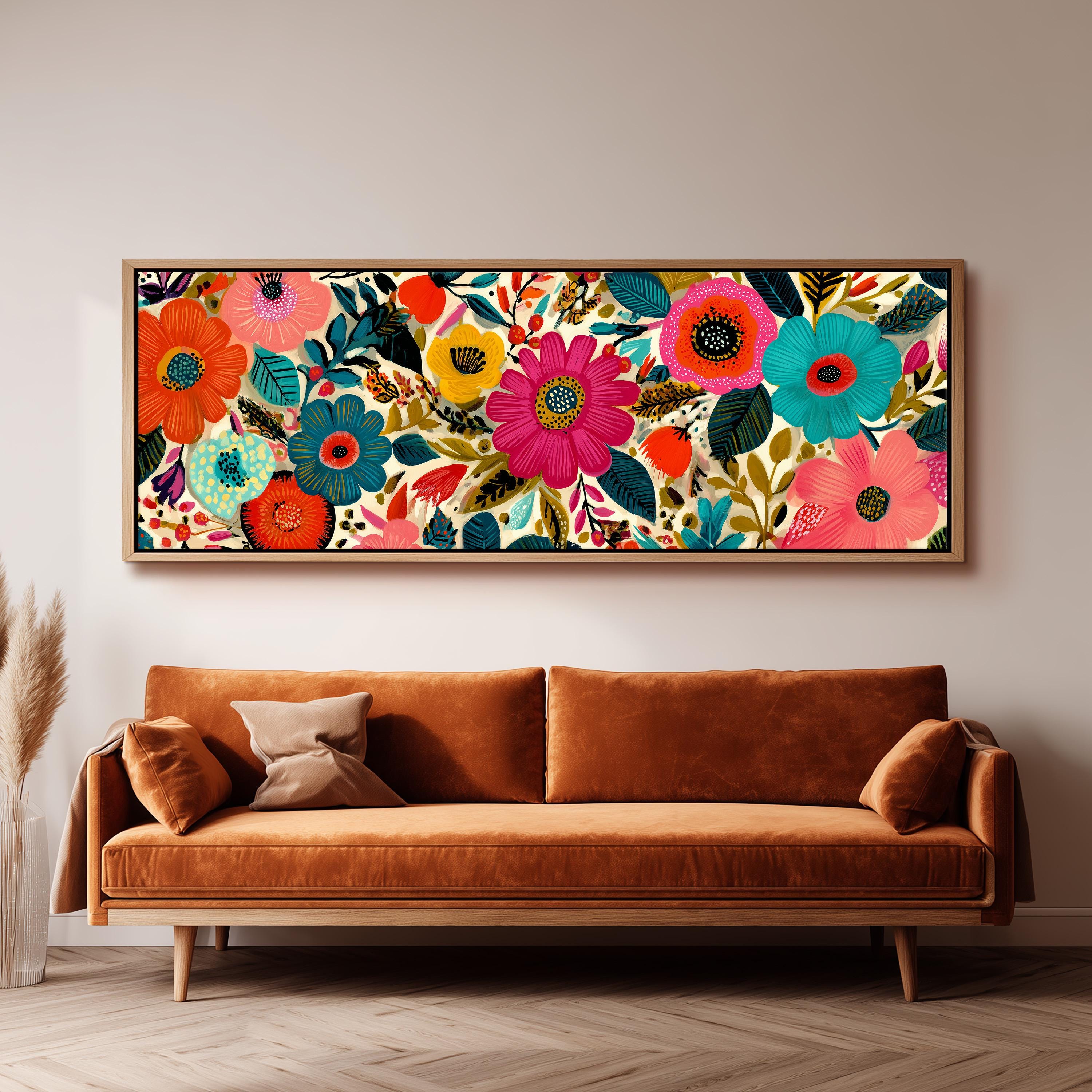a large, colorful floral print hanging on a wall above a brown sofa.