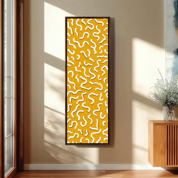 a large, abstract painting with a yellow and white color scheme, hanging on a wall in a room with a wooden cabinet and a vase of flowers.