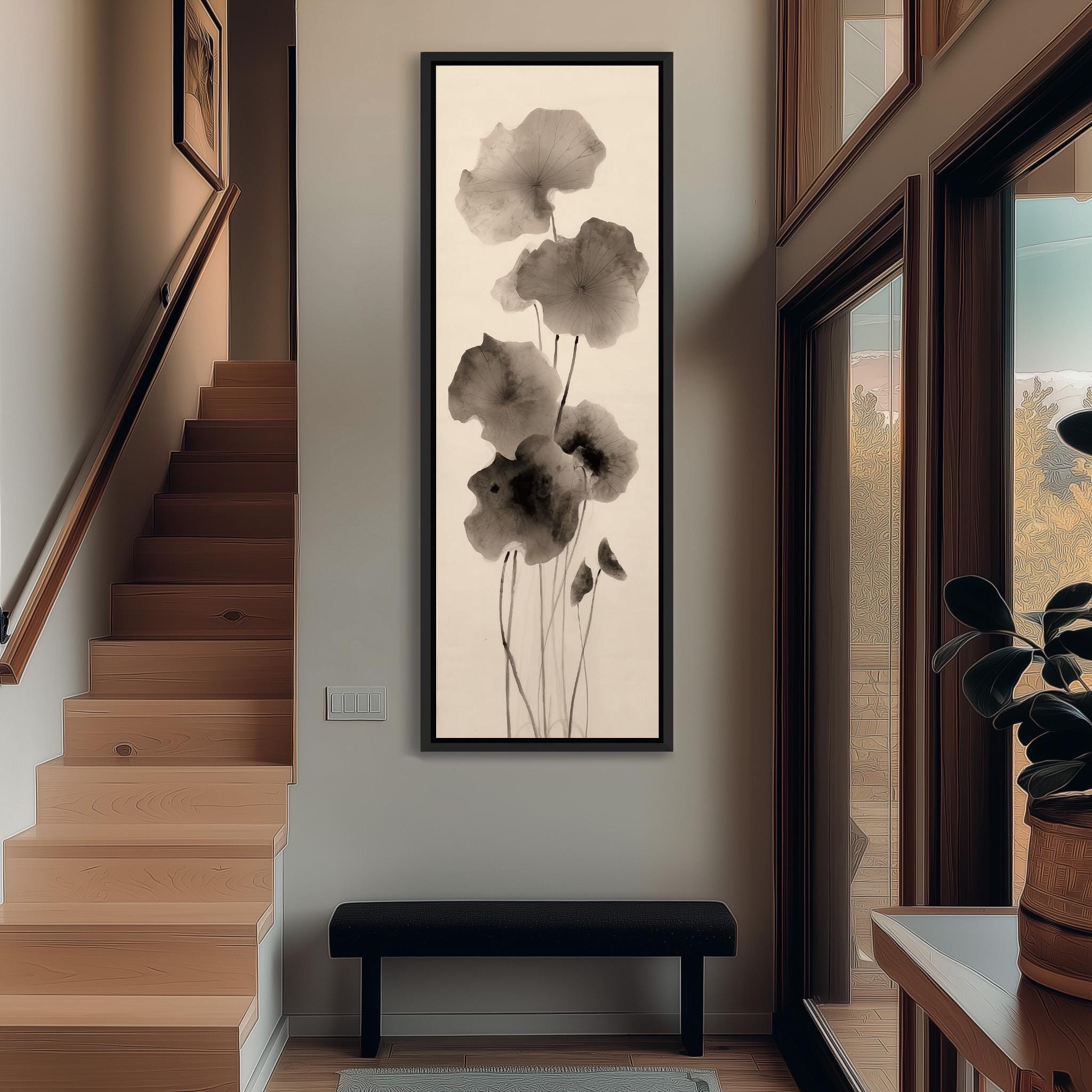 a hallway with a large black and white painting of flowers hanging on the wall. The painting is framed and appears to be a monochromatic representation of the flowers. The hallway has a wooden staircase and a bench, creating a cozy and inviting atmosphere.