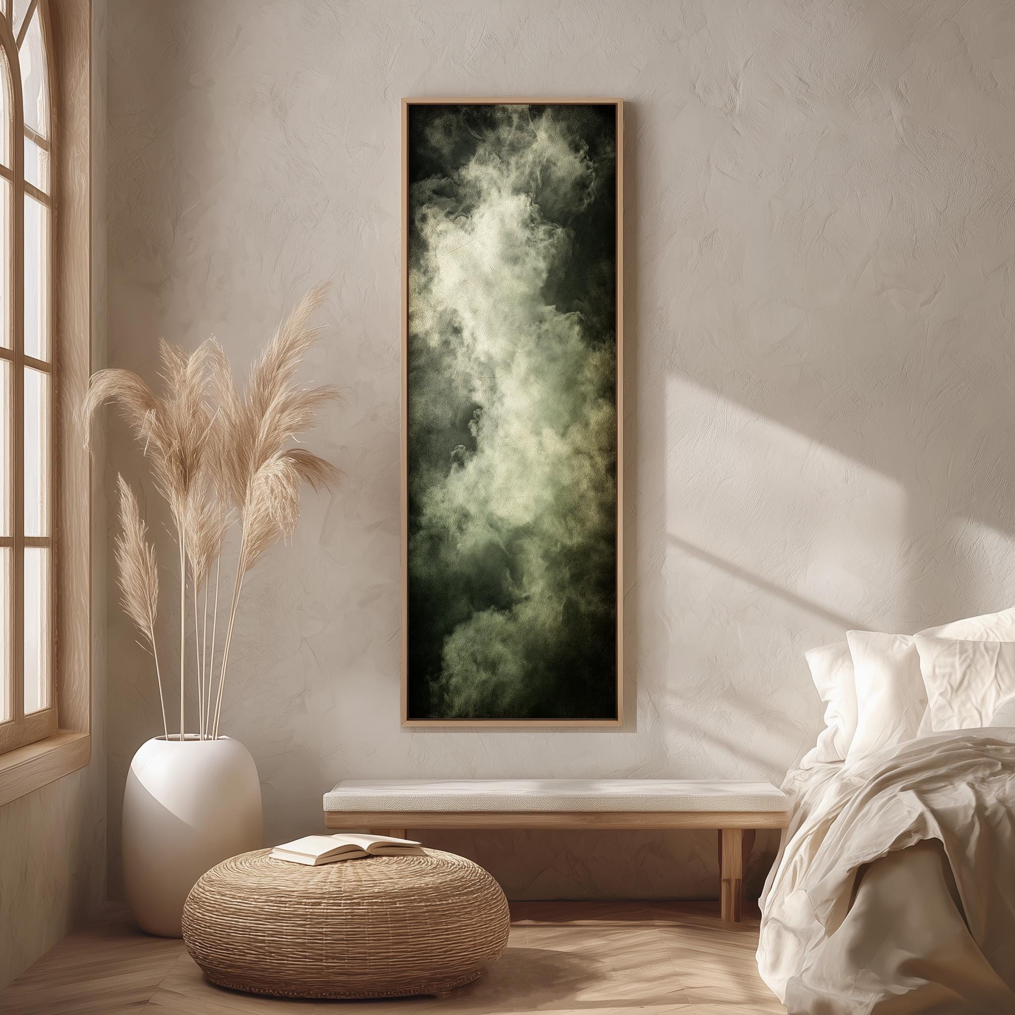 a serene and minimalist bedroom interior with a large window, a white bed, a wicker ottoman, and a framed artwork of a cloud-like image on the wall.