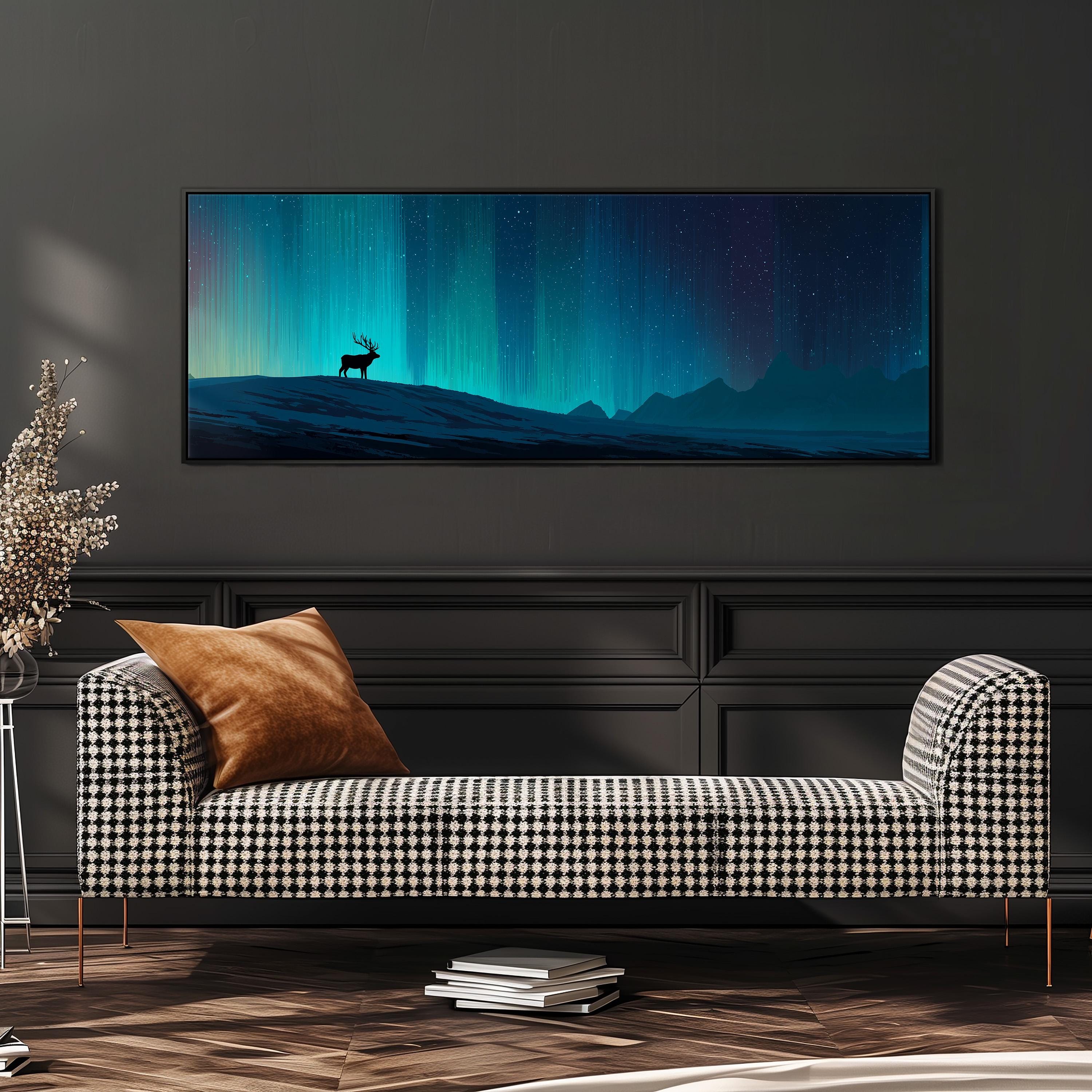 a large, framed painting of a deer standing on a hill against a night sky with a stunning display of the northern lights. The painting is hanging on a wall above a black and white checkered sofa, which is positioned in front of a stack of books.