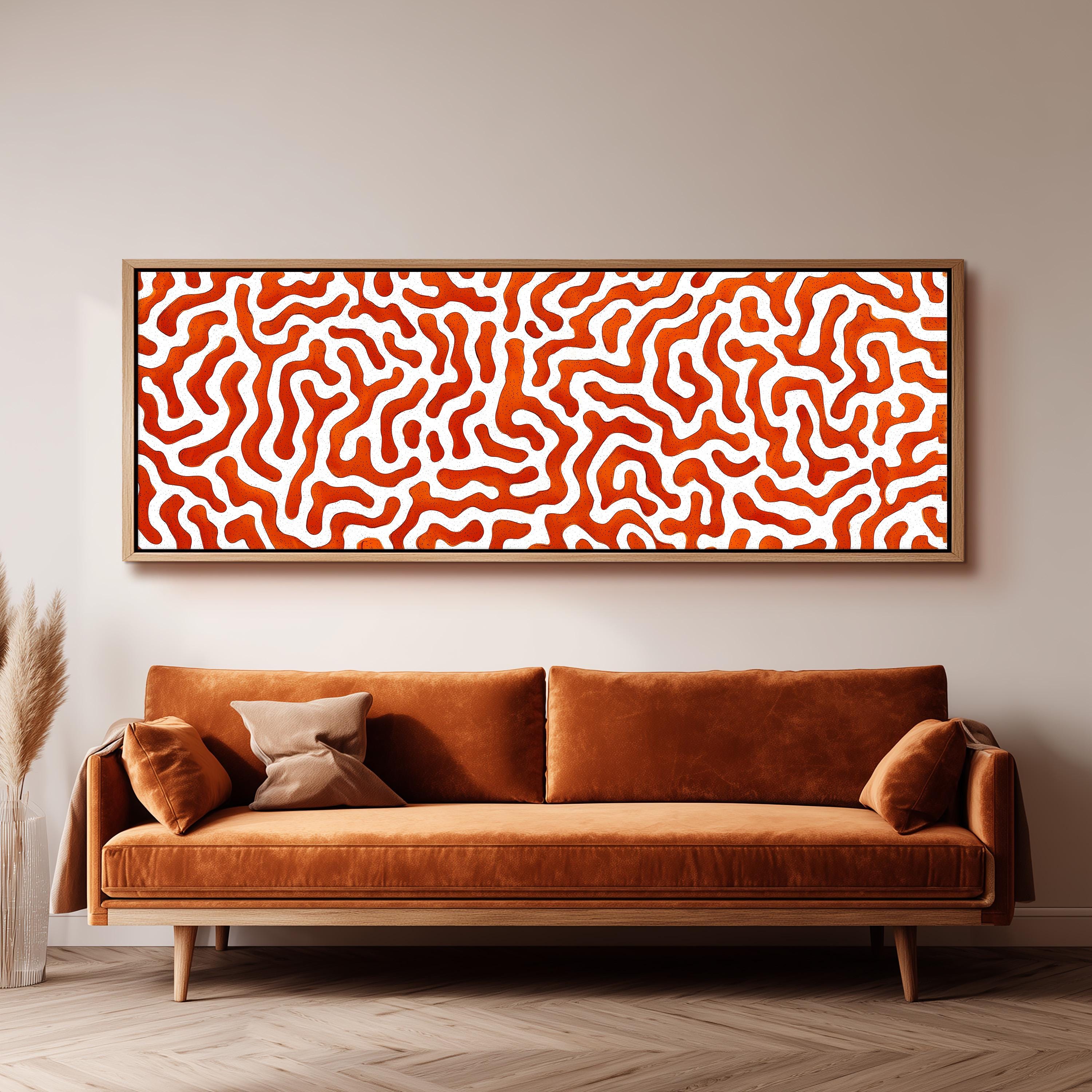 a large, abstract painting hanging on a wall above a brown sofa with two pillows.