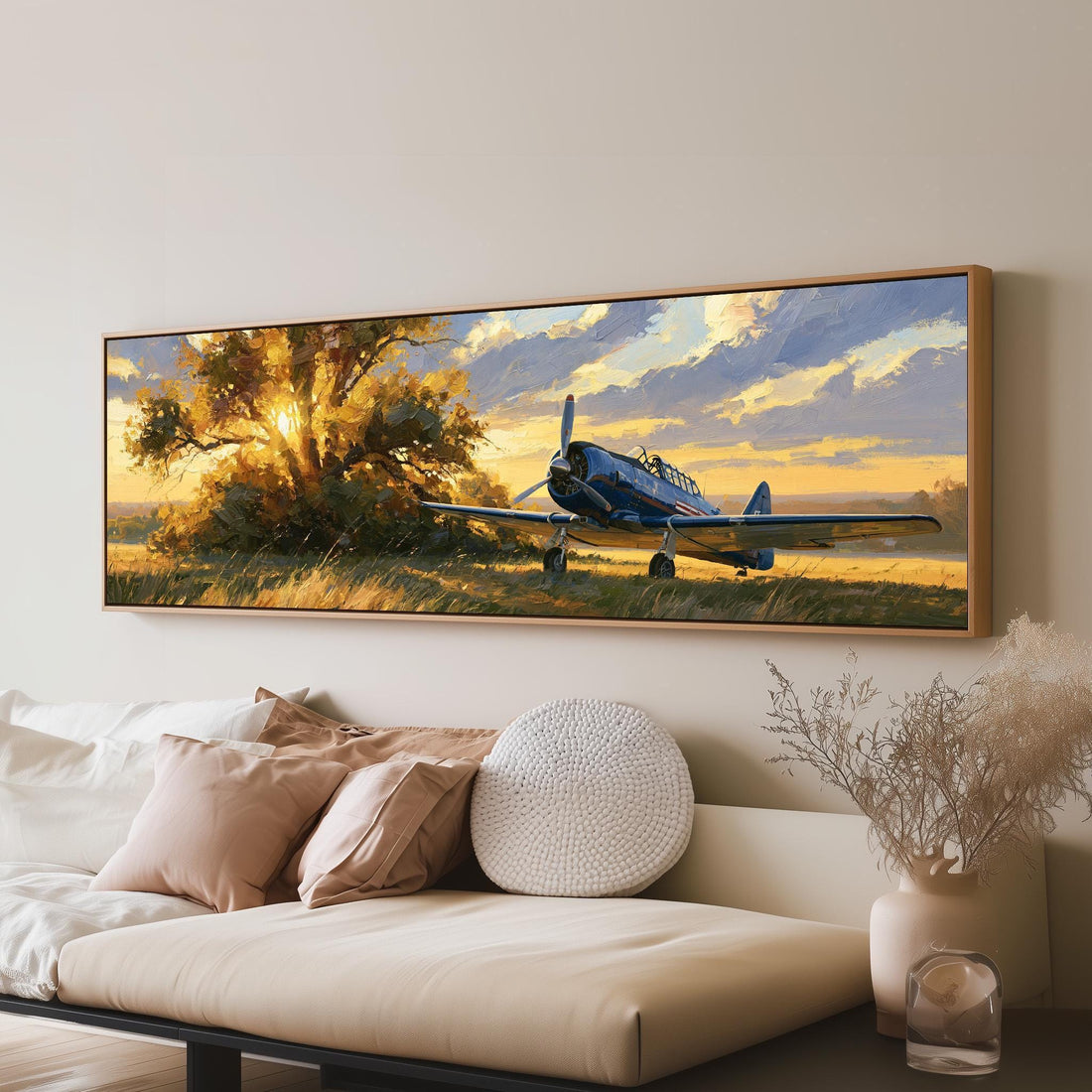 Vintage propeller plane under a tree at golden hour long horizontal canvas print above a sofa in a living room