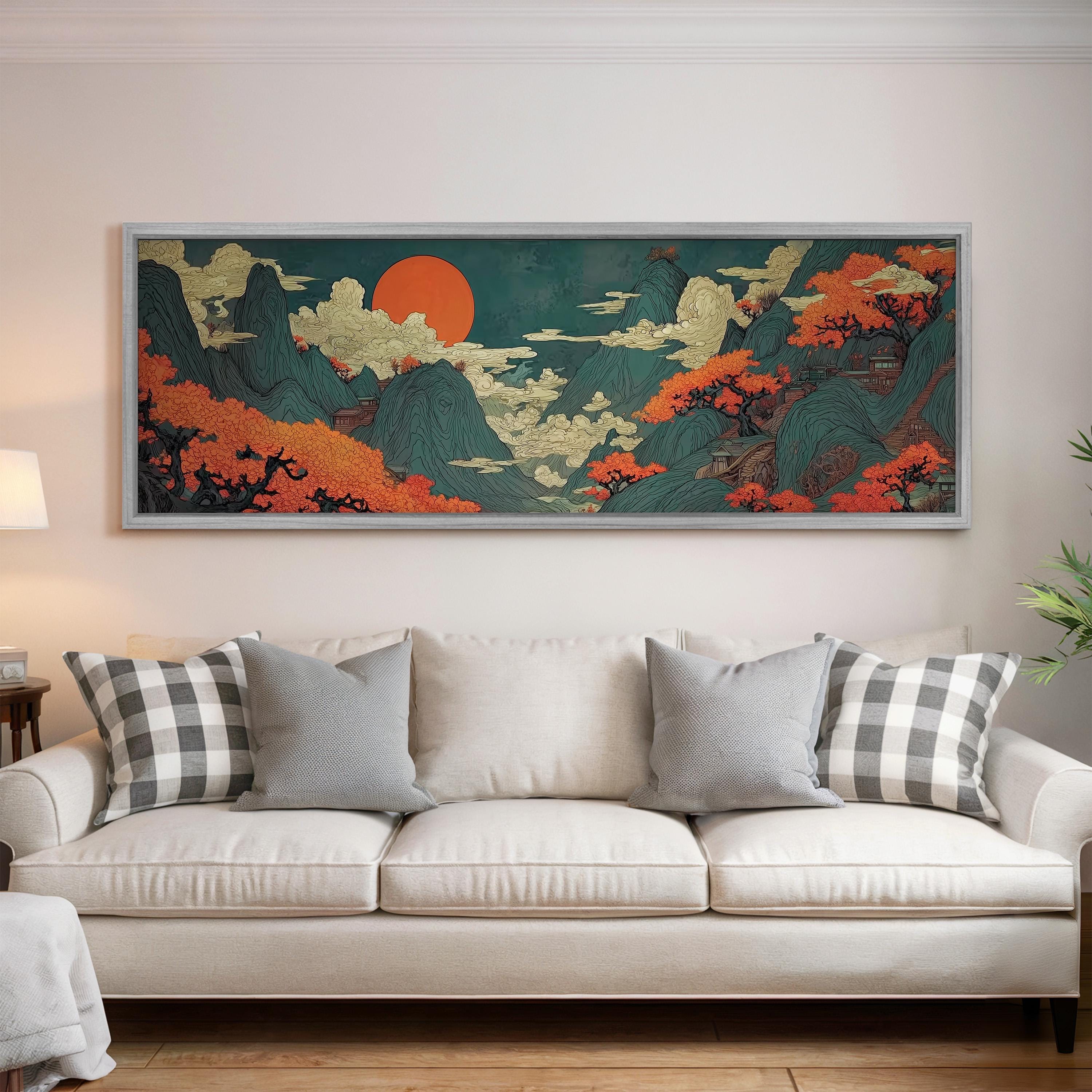 a large, colorful painting of a landscape hanging on a wall above a white couch with gray and white patterned pillows.