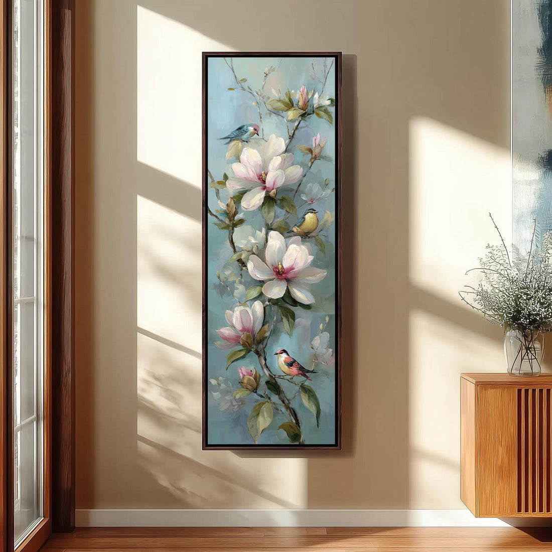 a large painting of a flower-filled branch hanging on a wall, with birds perched on the branches.