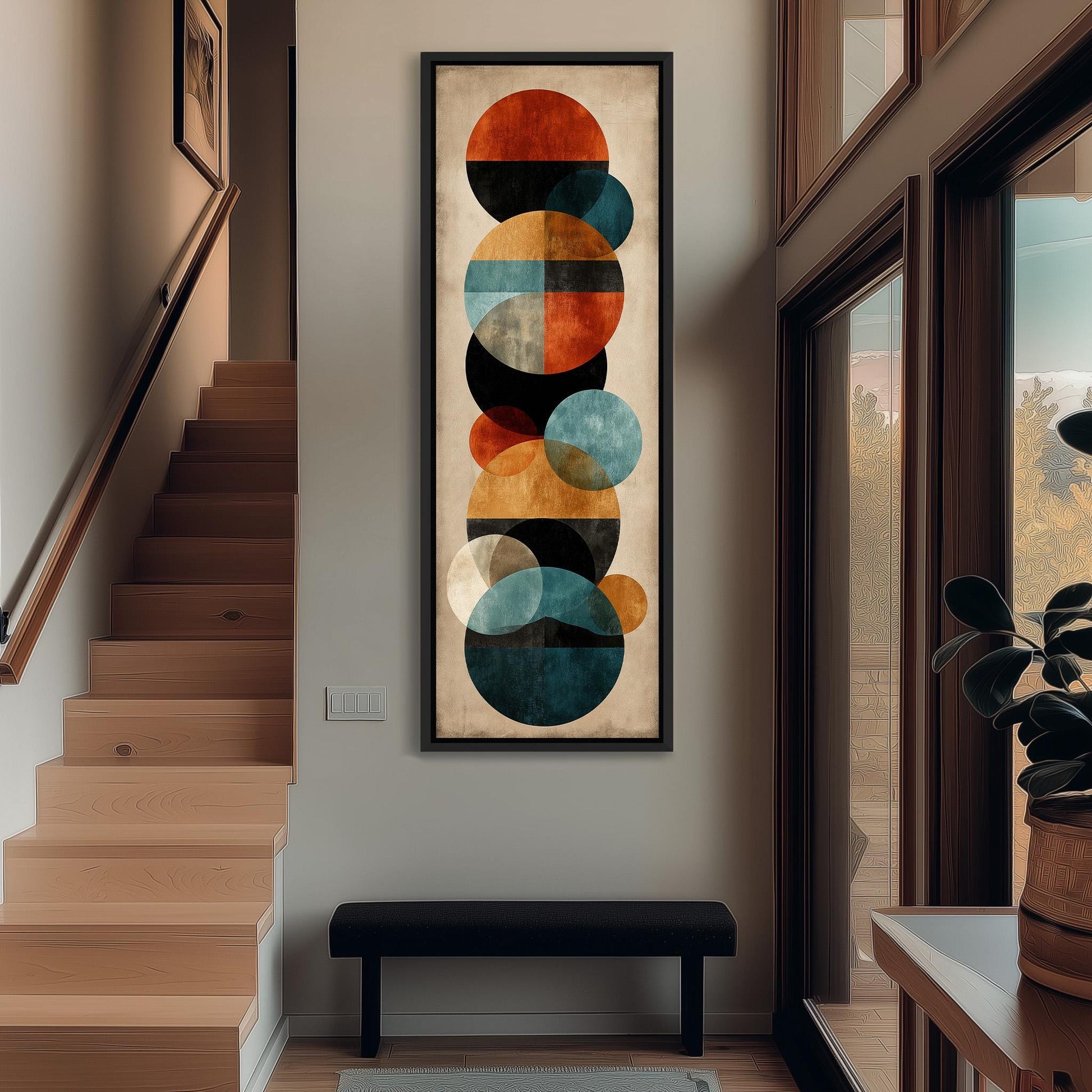 a modern art piece with a geometric design of circles and other shapes, hanging on the wall of a hallway.
