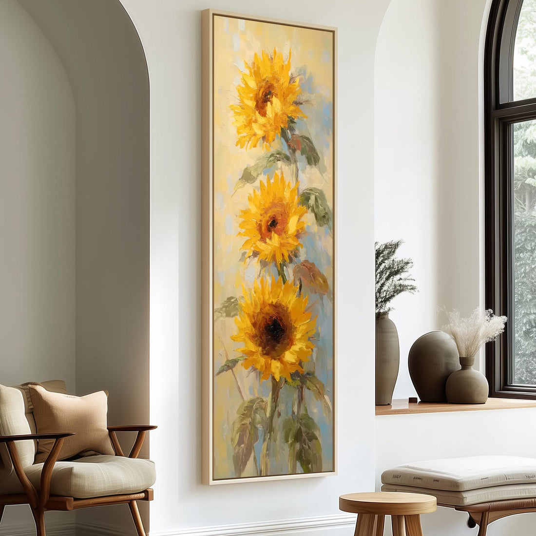 a large painting of three sunflowers hanging on a white wall in a room with a wooden chair and a small table.