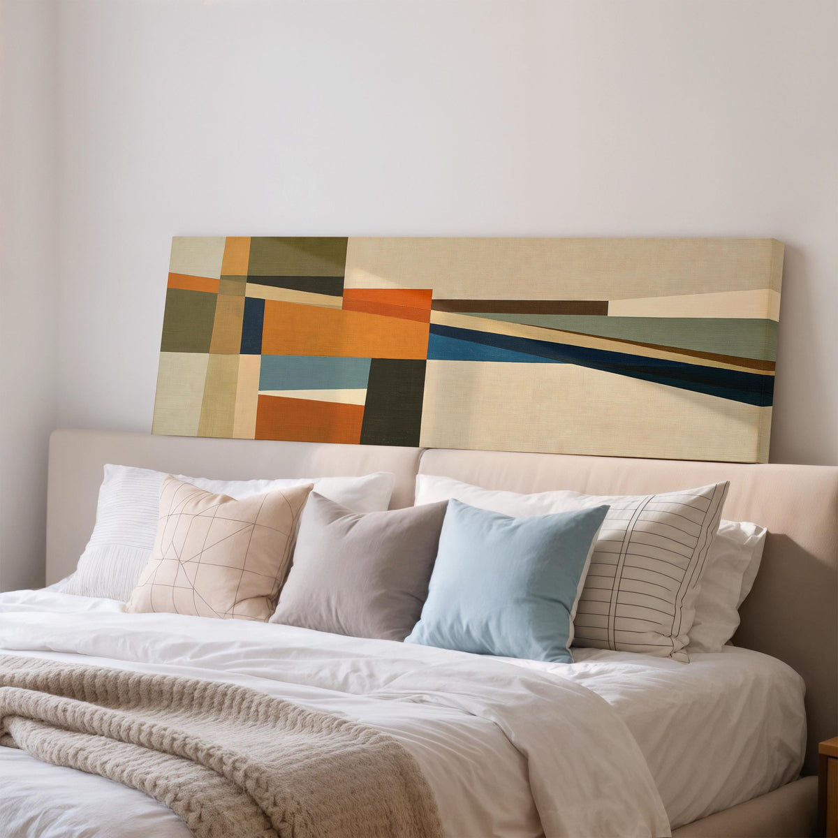 Olive and rust geometric blocks wide panoramic canvas print above a bed in a bedroom