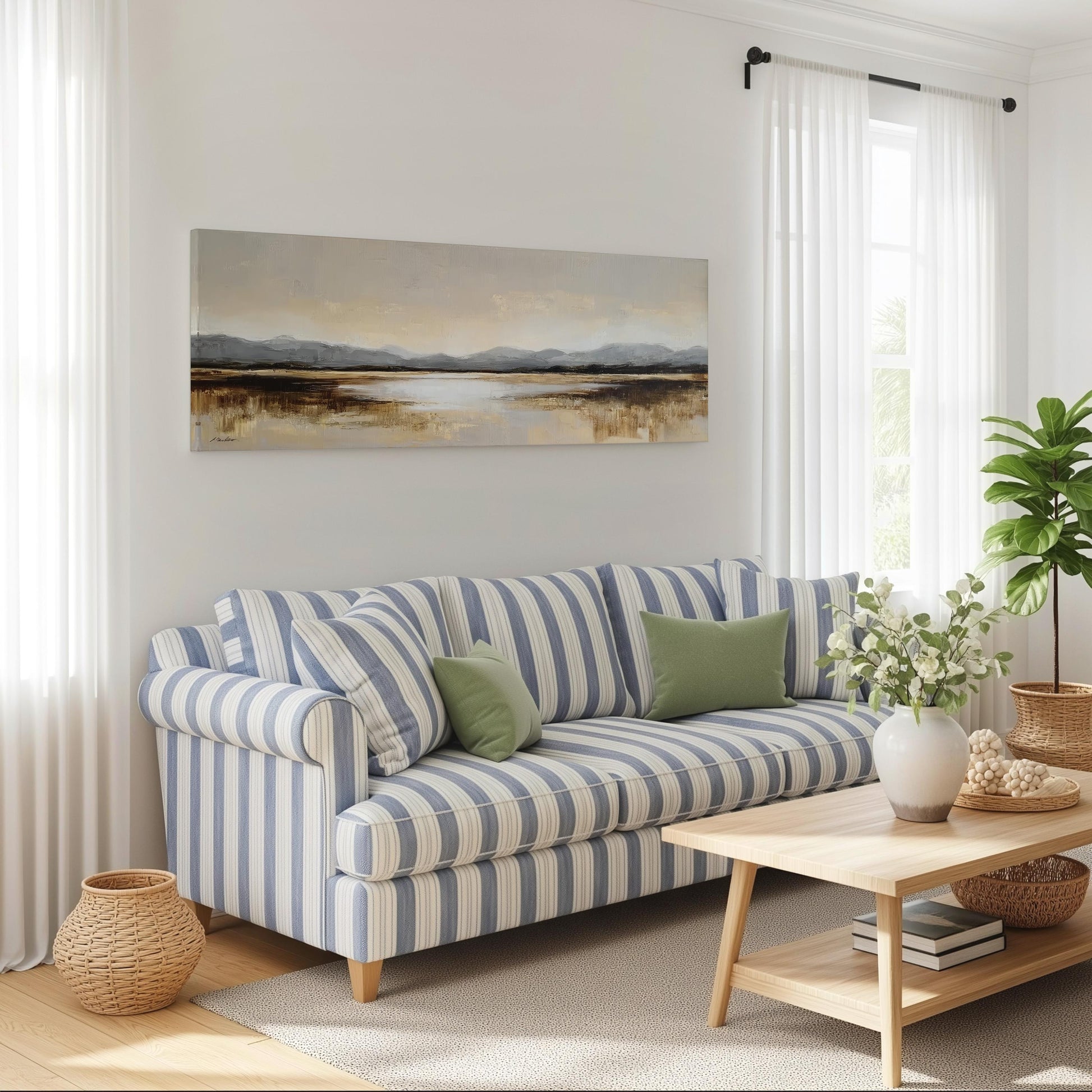 a cozy living room with a striped blue and white sofa, a wooden coffee table, and a large landscape painting on the wall.