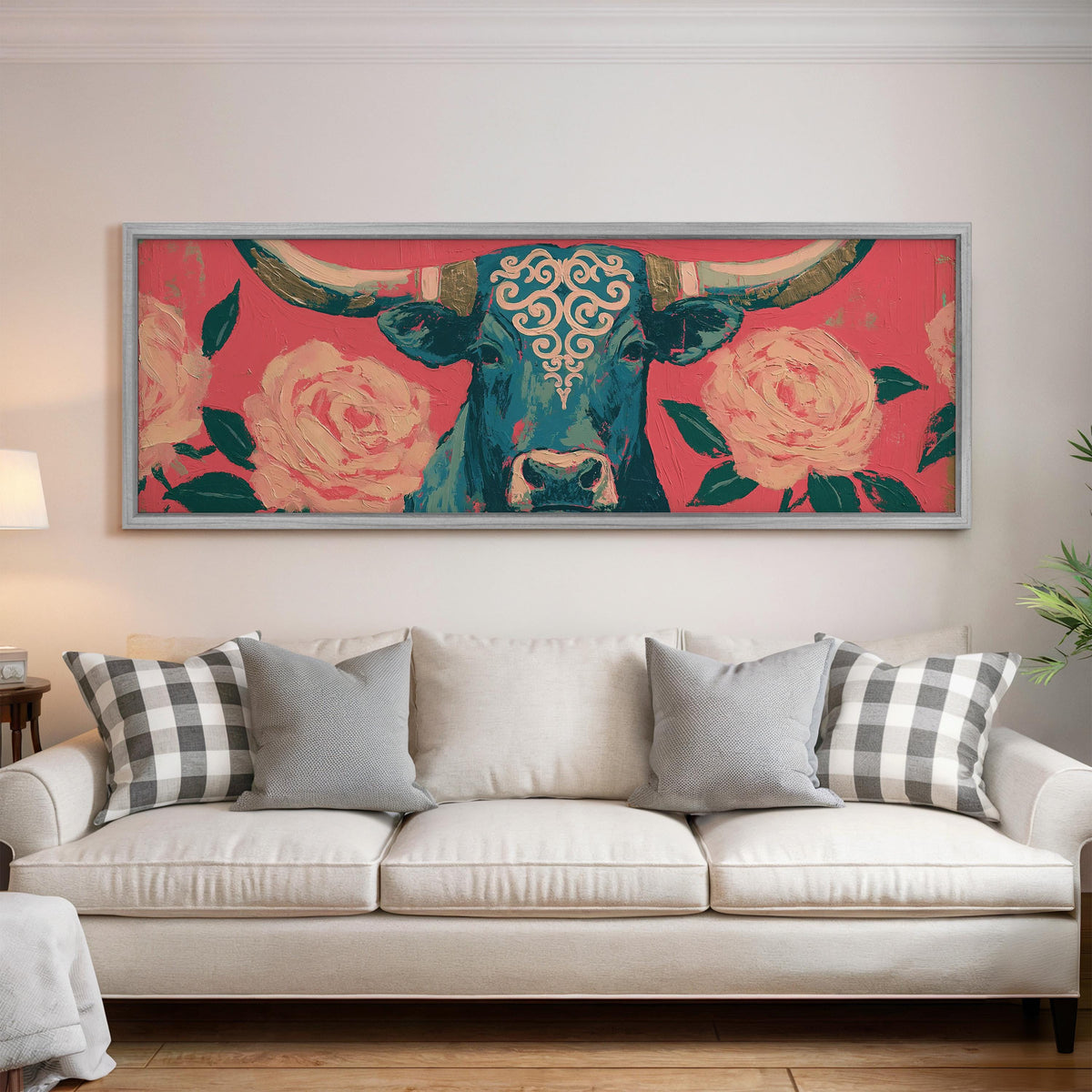 Longhorn with pink roses panoramic canvas print above a white sofa in a bright living room