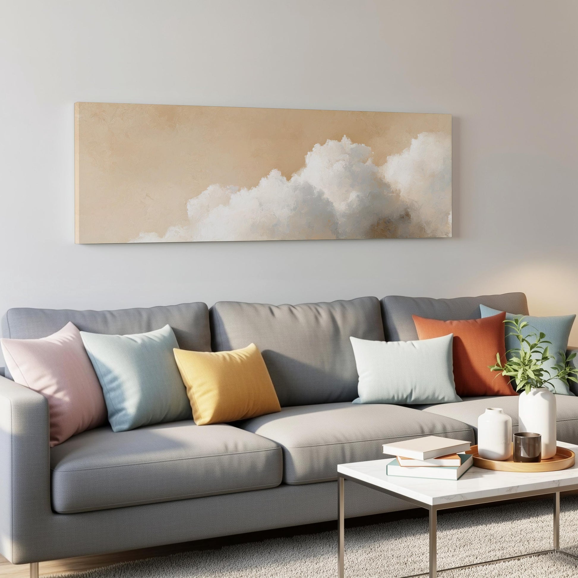 a modern living room with a gray sofa adorned with colorful throw pillows, a white coffee table, and a framed artwork depicting a cloud-filled sky on the wall above the sofa.