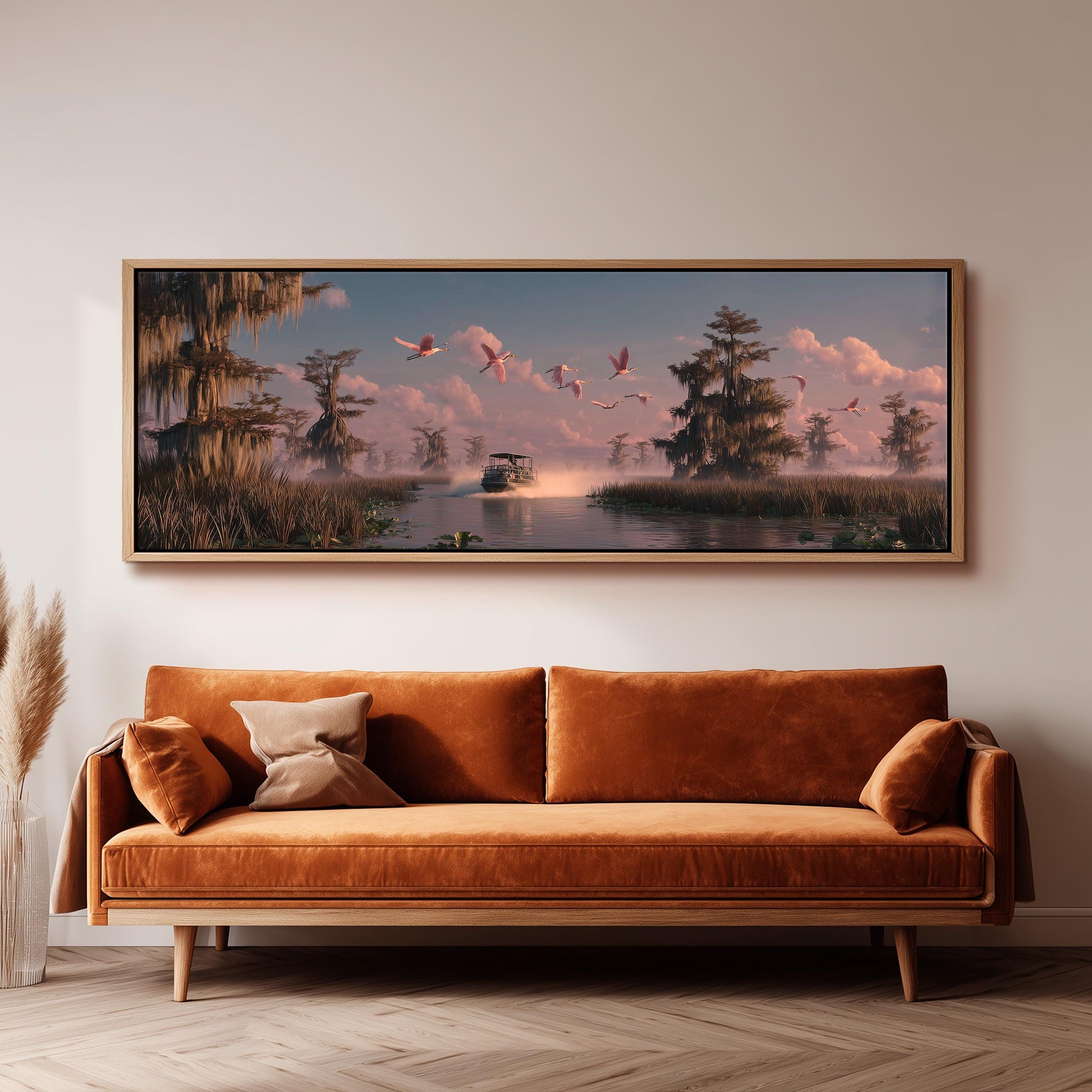 a large, framed painting of a serene landscape with a boat on a river, surrounded by lush greenery and a pink sky. The painting is hung on a wall above a brown sofa, creating a cozy and inviting atmosphere in the room.