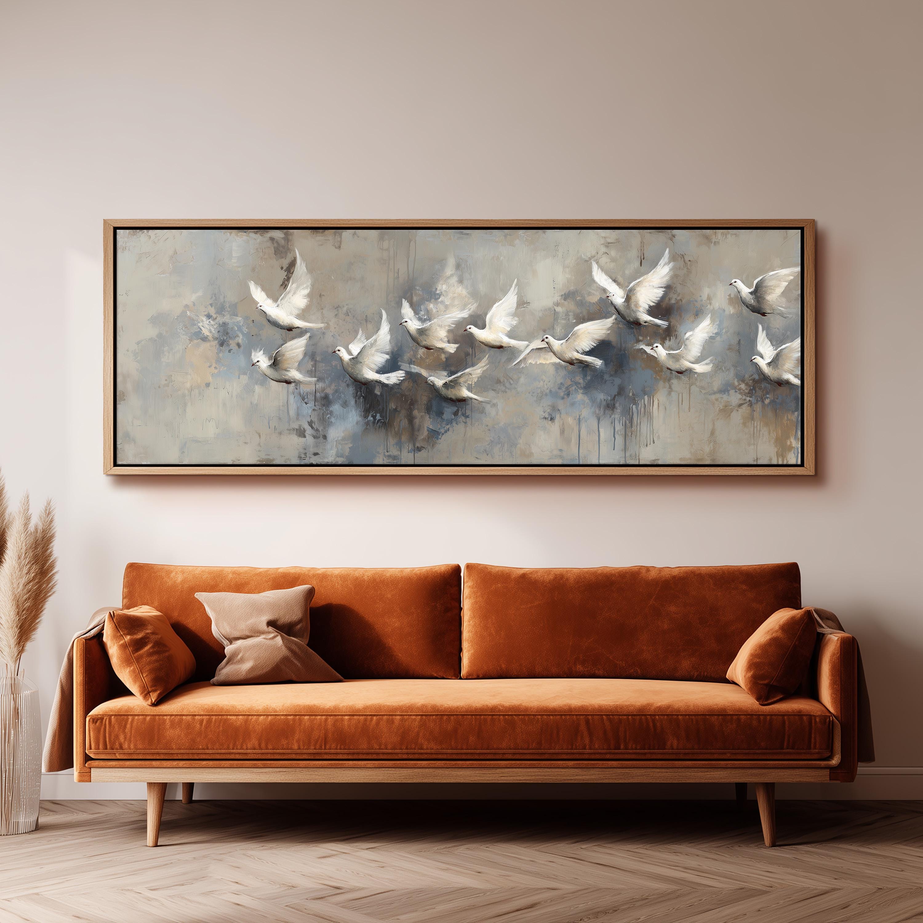 a large painting of white birds flying over a gray background, hanging on a wall above a brown sofa.