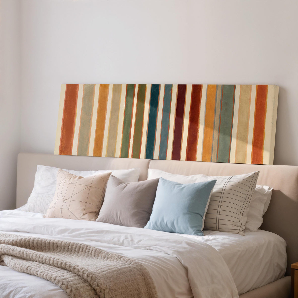 Rust, sage, maroon and teal stripes wide panoramic canvas print above a bed in a bedroom