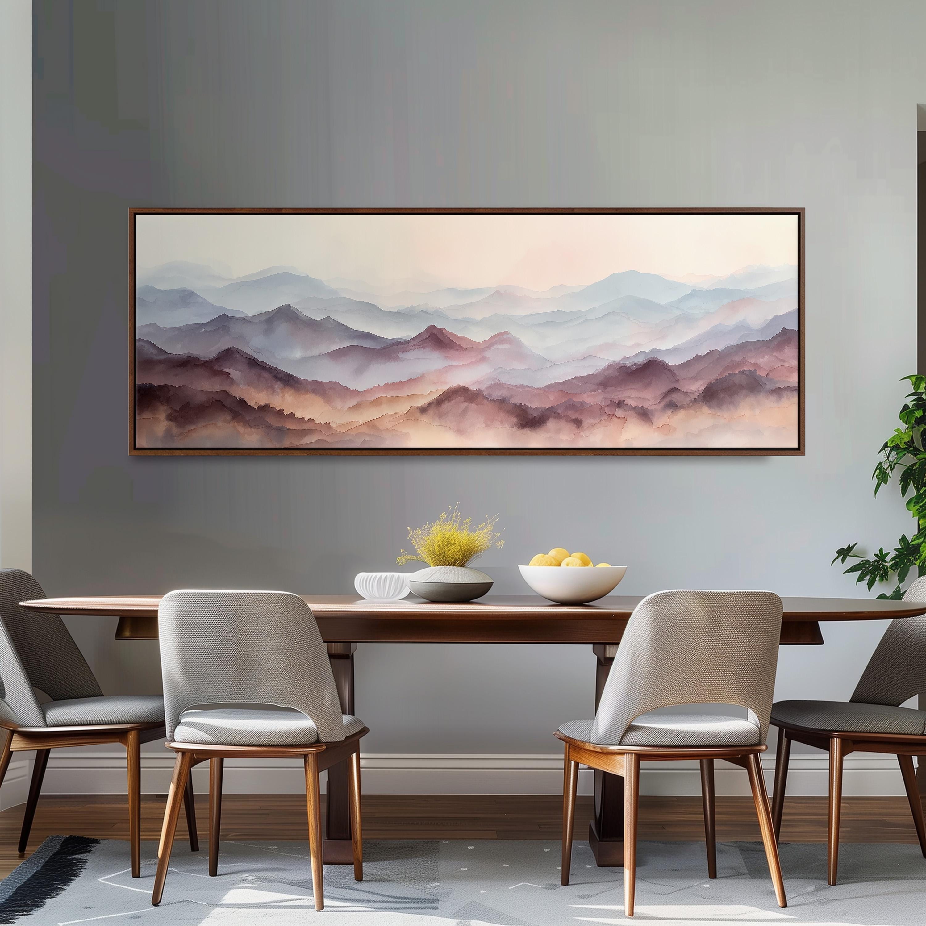 a dining room with a large painting of a mountain landscape hanging on the wall above a wooden dining table with four chairs. The table is set with a bowl of fruit and a vase of flowers, creating a cozy and inviting atmosphere.