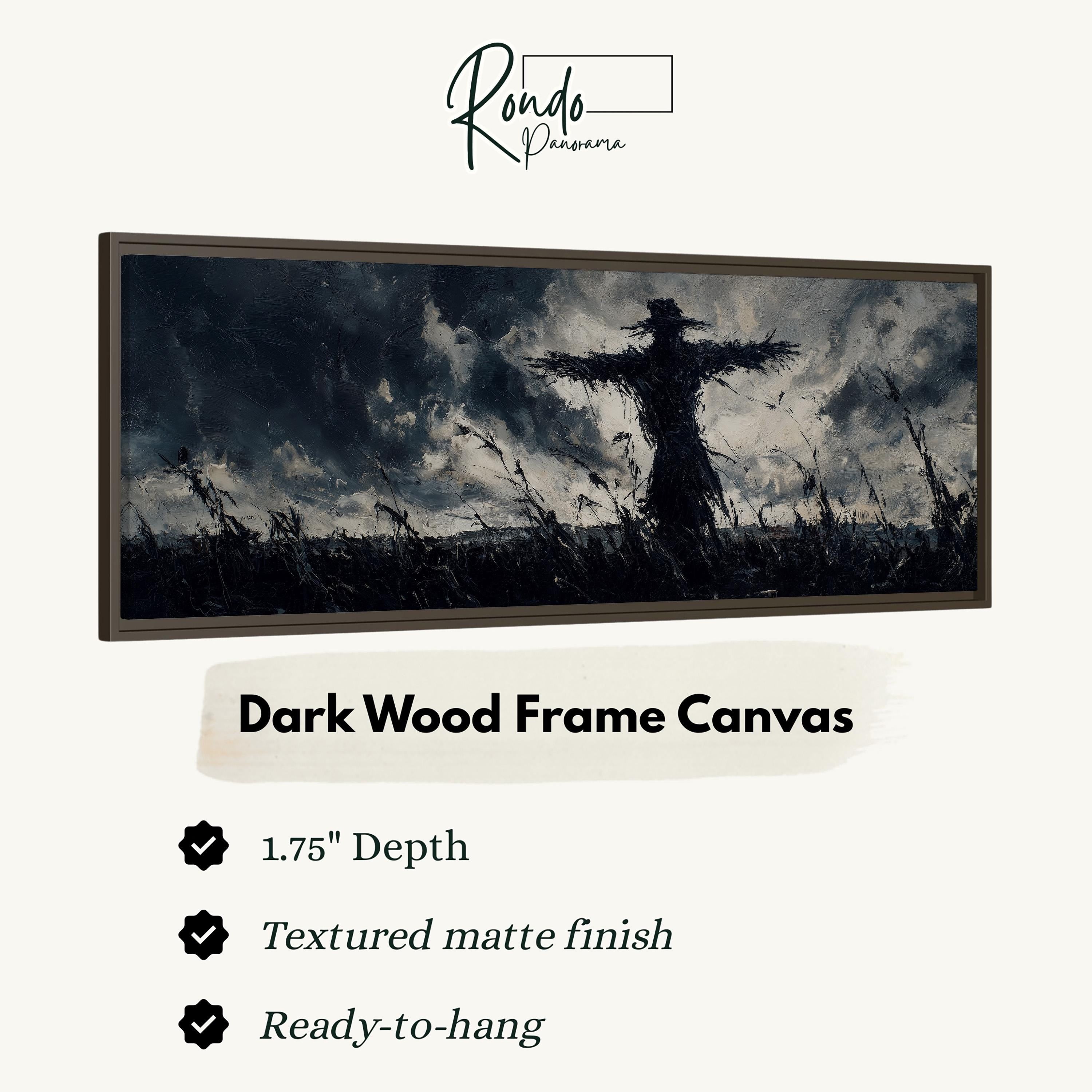 The image is a dark wood frame canvas depicting a silhouette of a scarecrow standing in a field with a cloudy sky in the background.