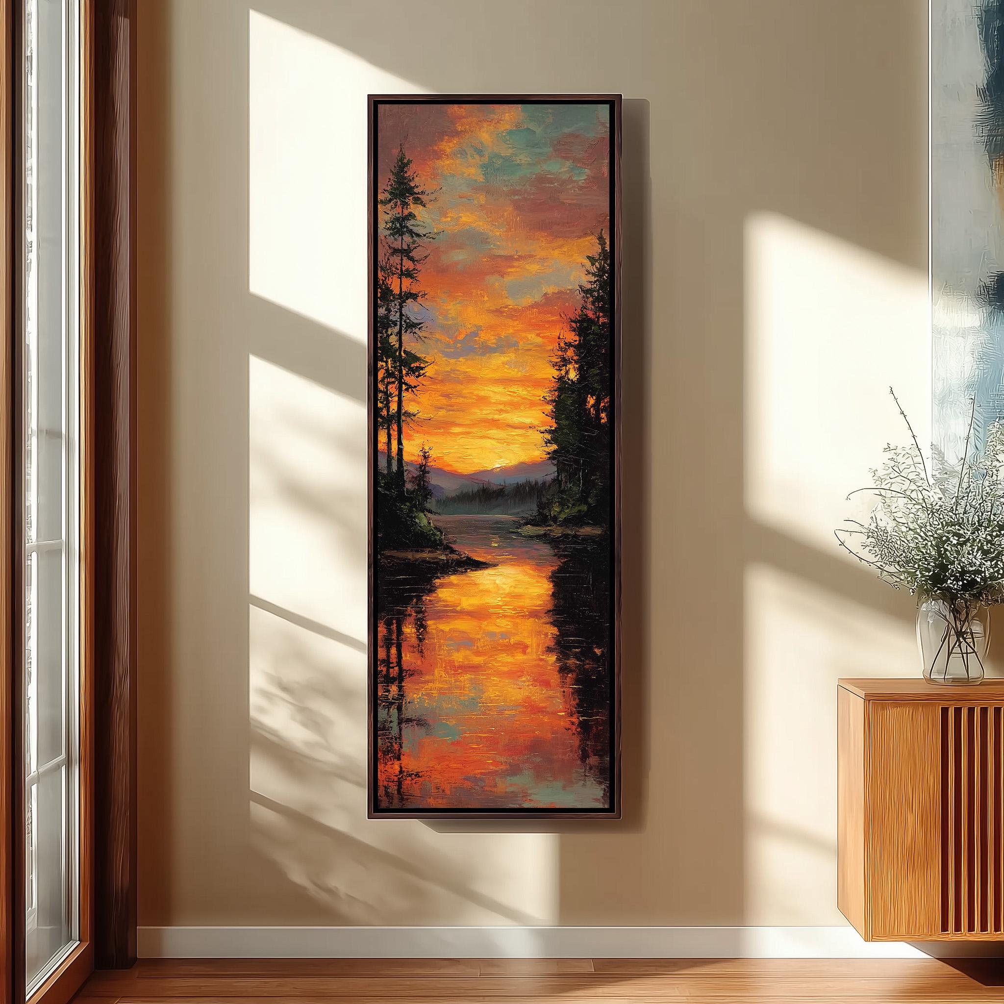 a large framed painting hanging on a wall, depicting a serene landscape with a lake reflecting the vibrant colors of the sunset.