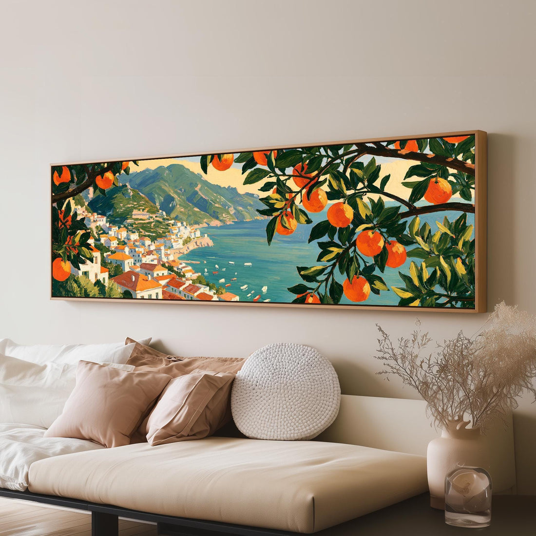 Italian coastal village seen through orange trees long horizontal canvas print above a sofa in a living room