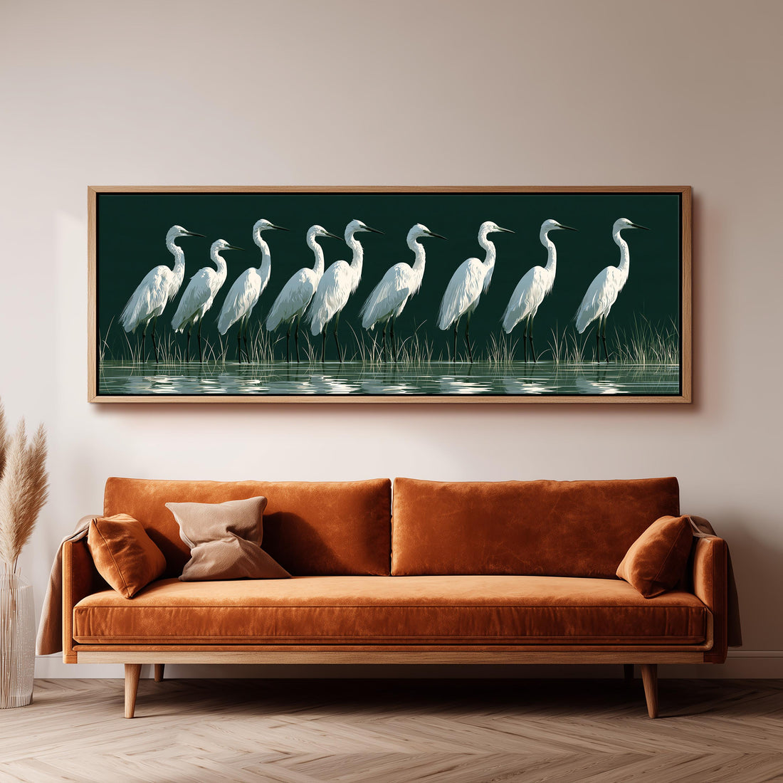 Row of white egrets on deep green long horizontal canvas print above a sofa in a living room