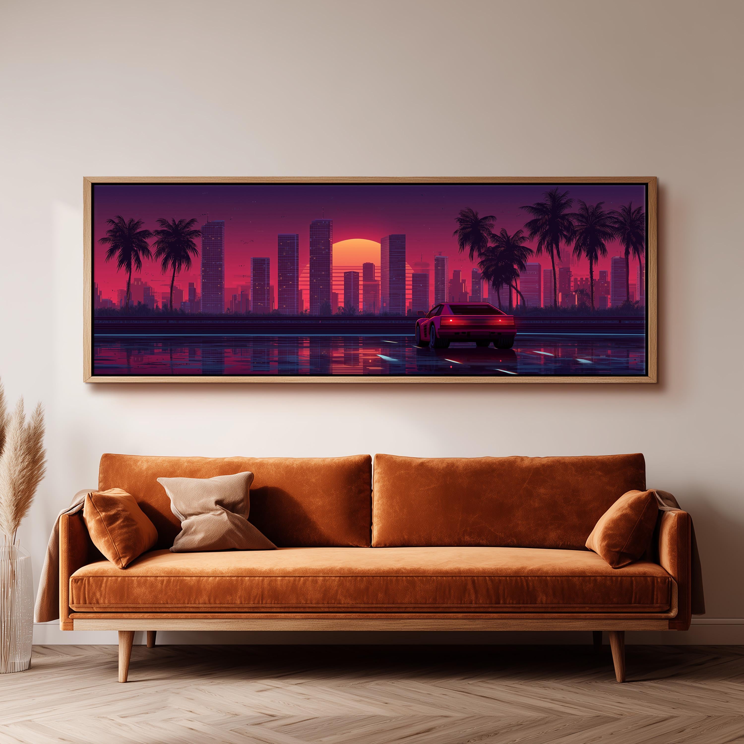 a large, framed painting of a cityscape with palm trees and a car driving on a road, all set against a vibrant sunset sky.