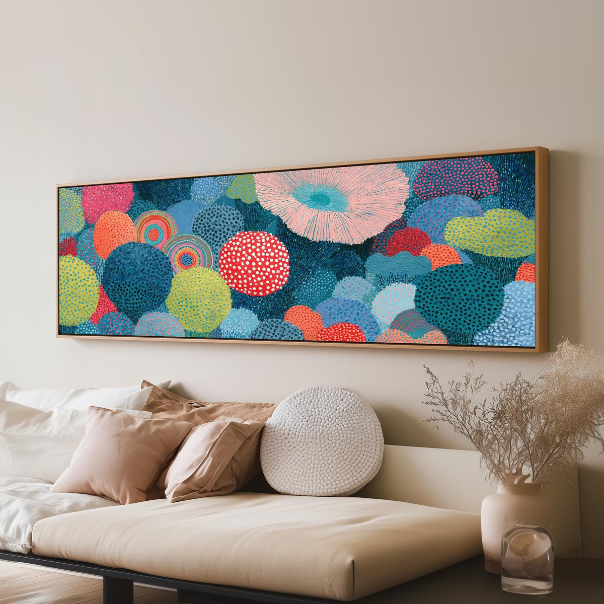 Coral spirals and dotted circles panoramic canvas print above a sofa in a living room