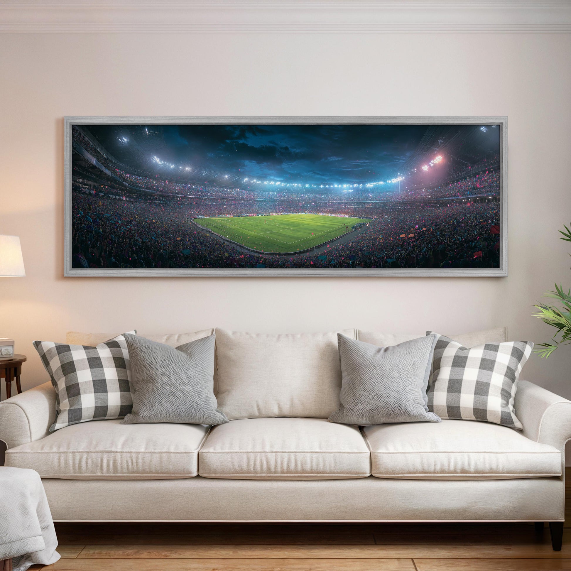 a large, framed picture of a soccer stadium with a green field and a crowd of spectators.