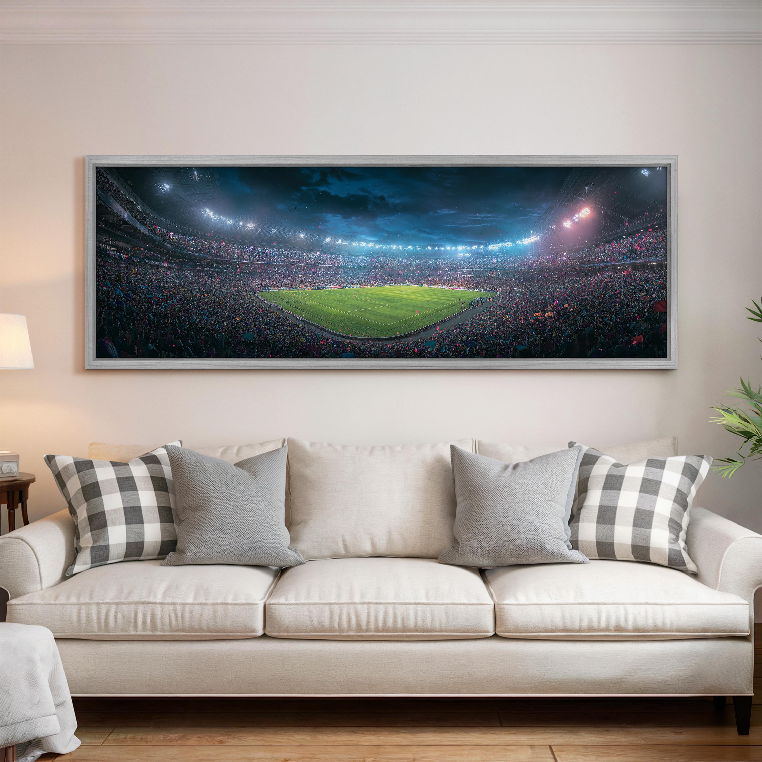 a large, framed picture of a soccer stadium with a green field and a crowd of spectators.