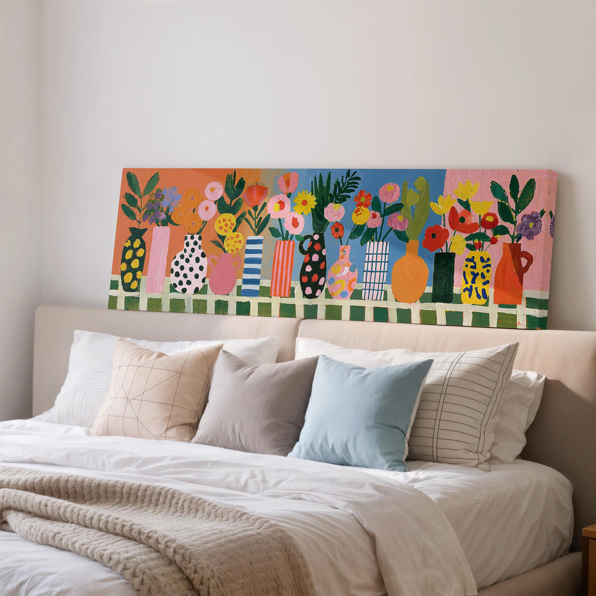 Patterned vases with bright bouquets wide panoramic canvas print above a bed in a bedroom