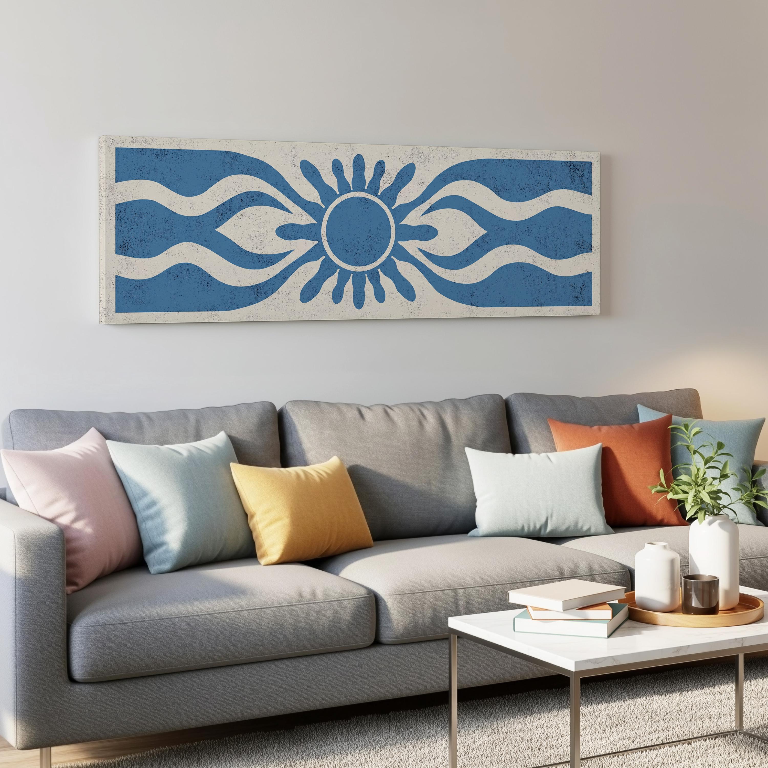 a gray couch with colorful throw pillows, a coffee table, and a large blue and white abstract artwork hanging on the wall above the couch.