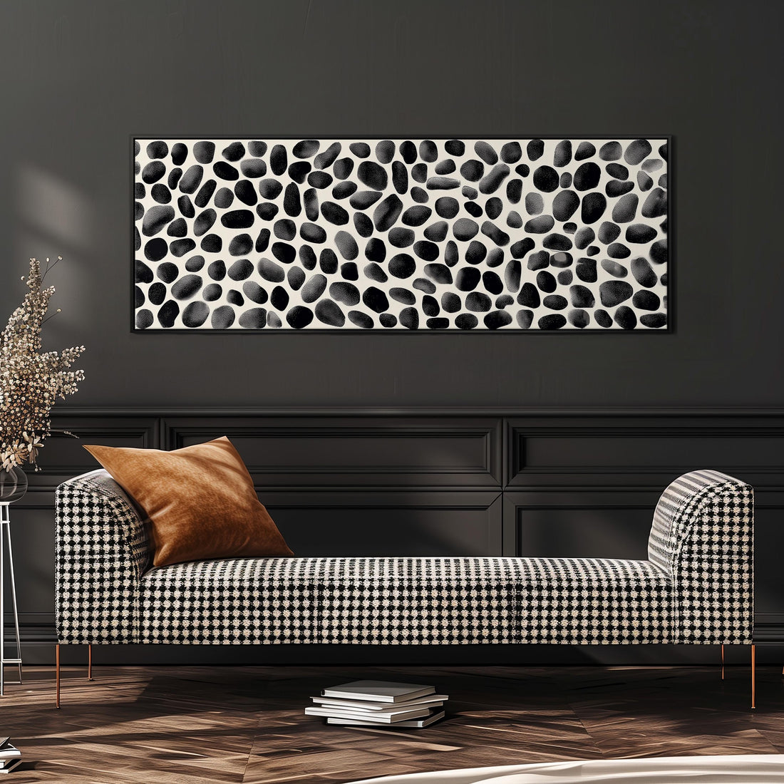a modern living room with a black and white checkered sofa, a stack of books, and a large abstract painting on the wall.