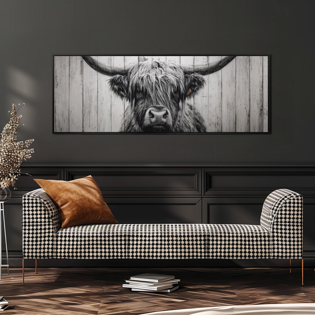 a large framed picture of a cow's face on the wall above a white couch with gray and white pillows.
